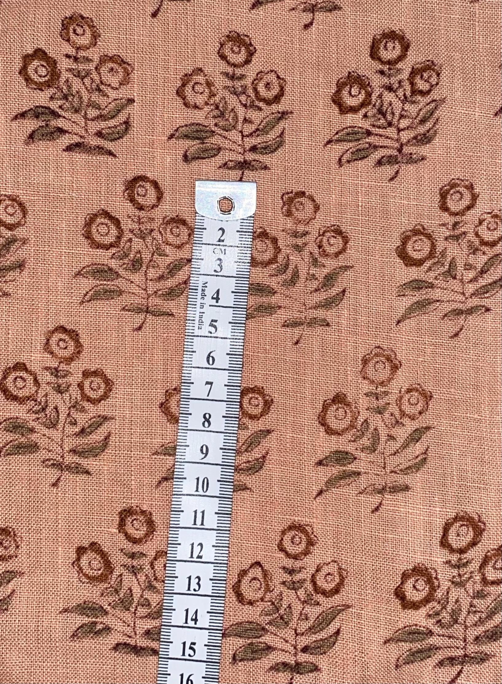 Hidden zipper and corner detail of peach floral linen pillow cover