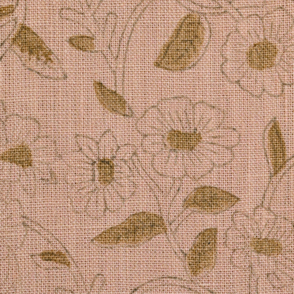 Blush pink floral linen pillow cover styled on a sofa