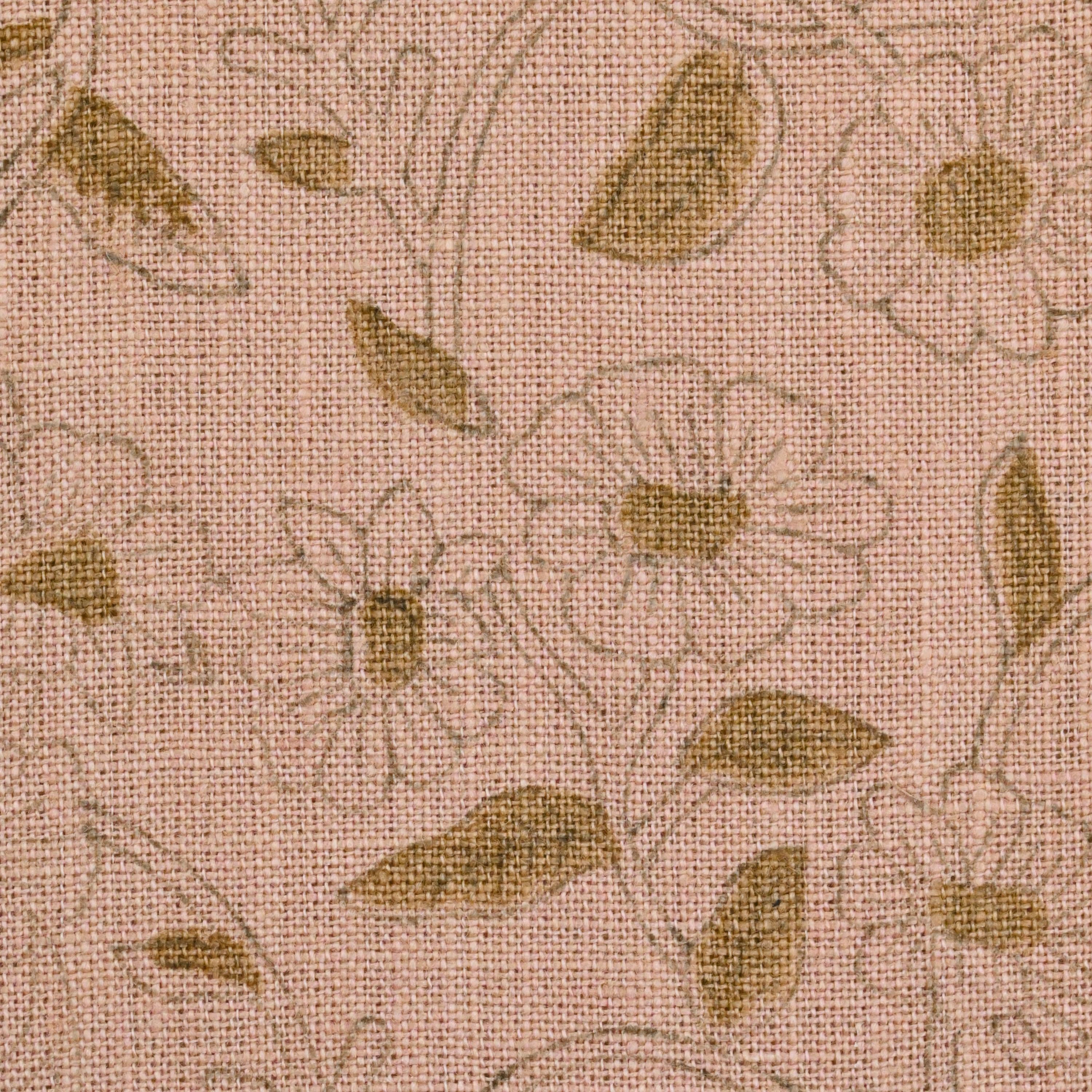 Blush pink floral linen pillow cover styled on a sofa