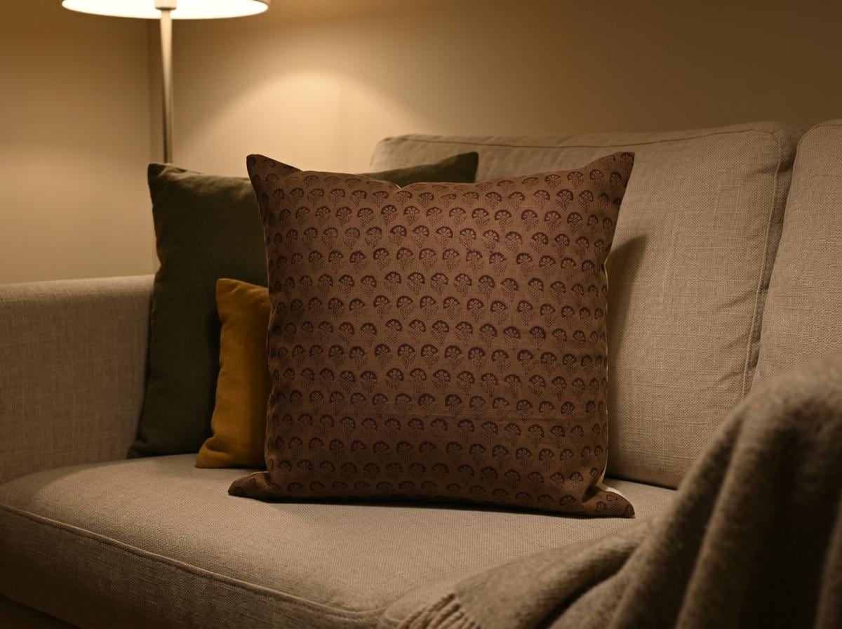 Brown floral block print linen pillow cover styled on a sofa