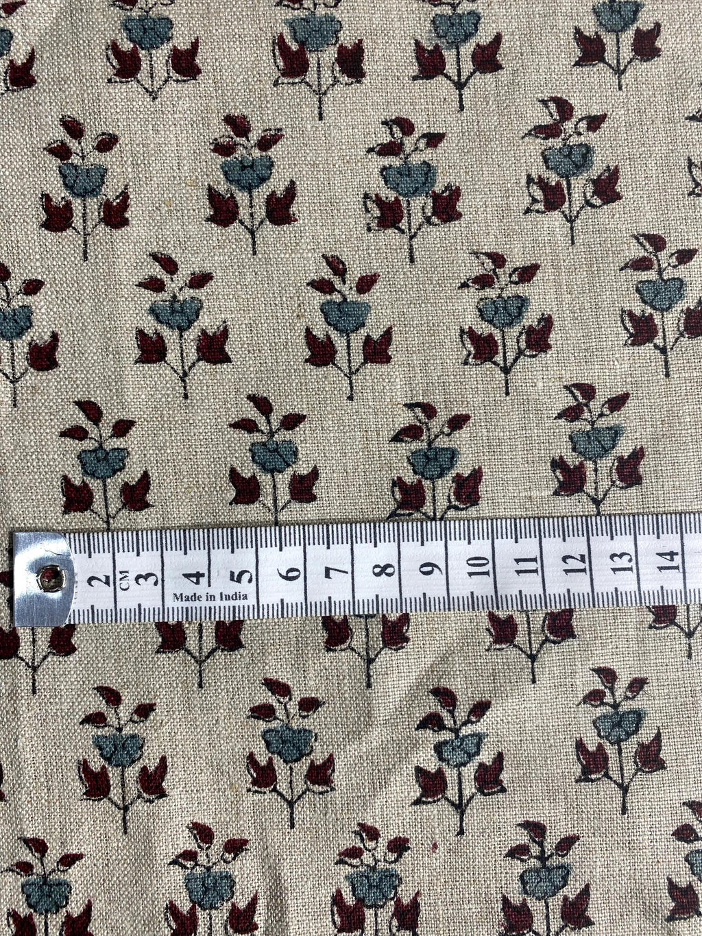 Close-up of navy floral block print motif on natural linen fabric
