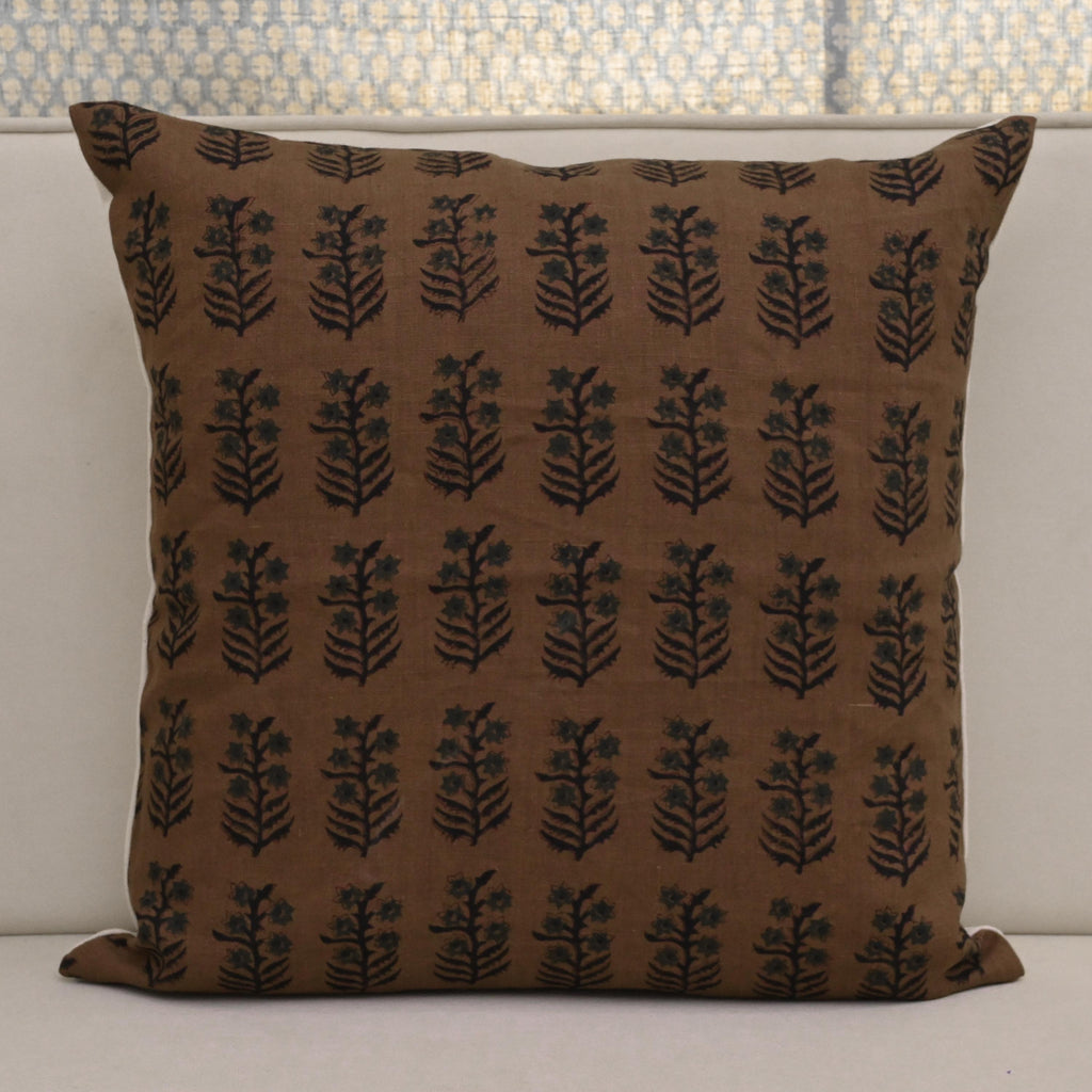 Brown floral block print pillow cover styled in a living room