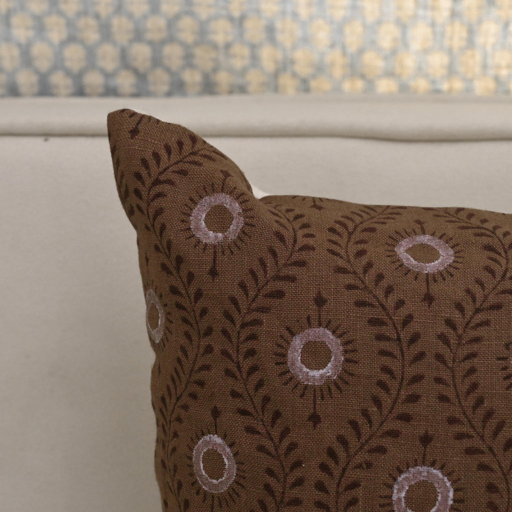 Corner detail of brown vine medallion linen pillow cover