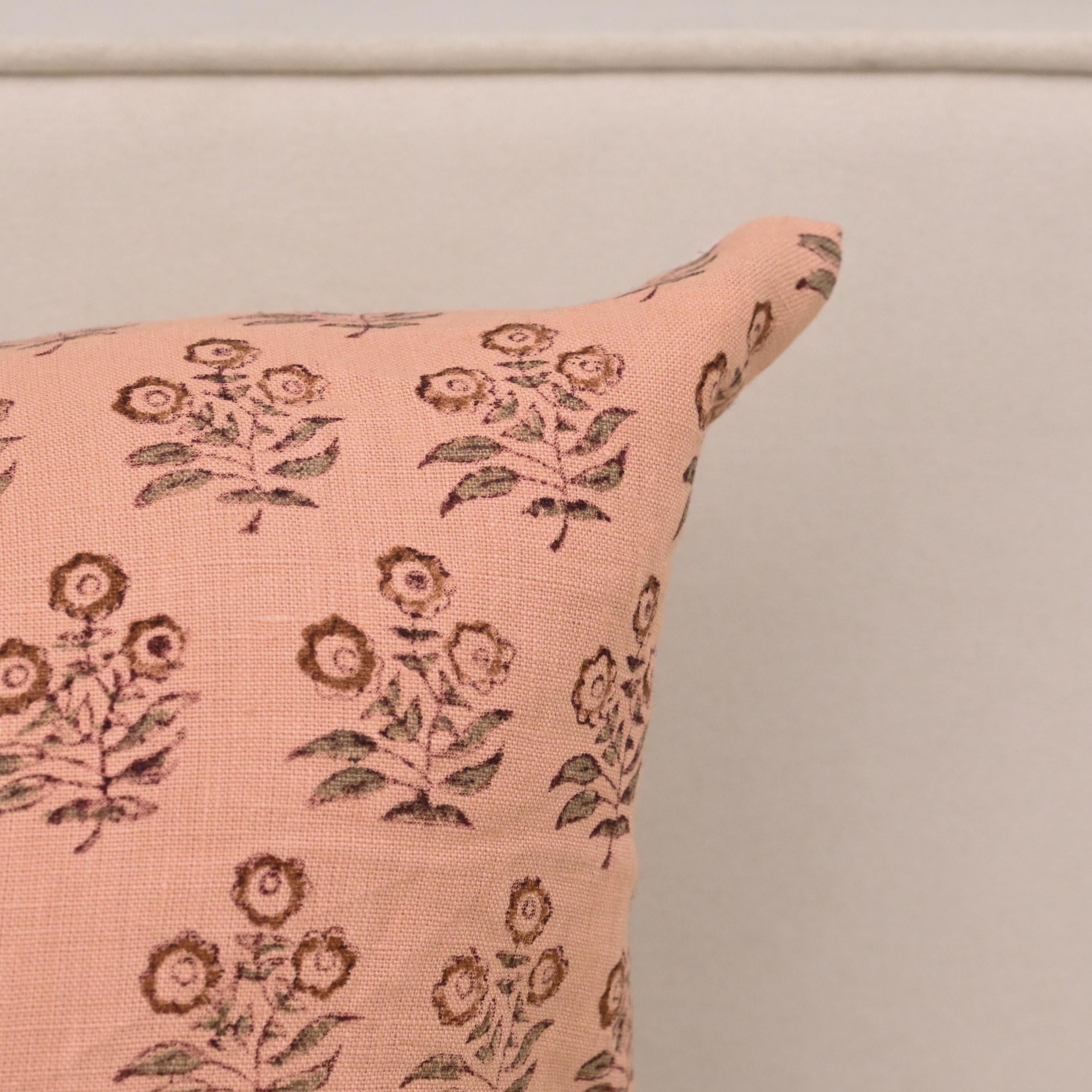Peach floral linen throw pillow cover styled on a sofa