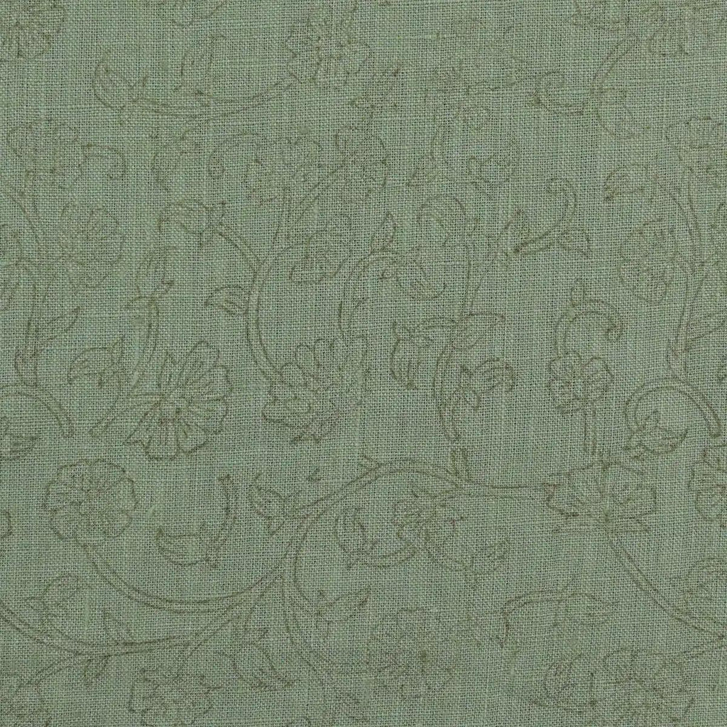 Sage green botanical block print linen pillow cover styled on a sofa