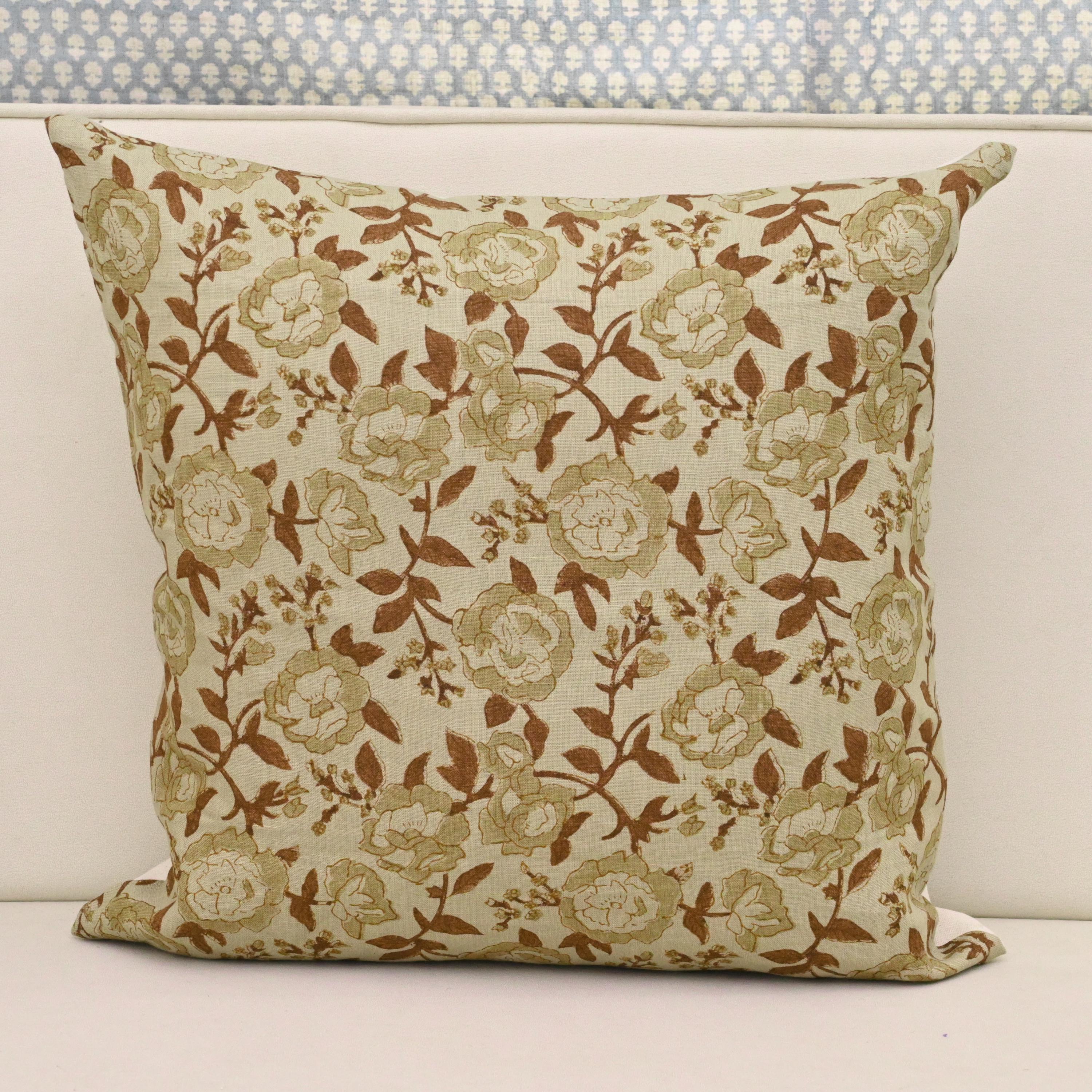 Sage green and rust brown hand block print linen pillow cover on ivory background