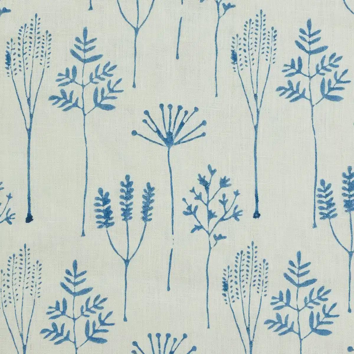 Blue botanical linen pillow cover styled on a sofa