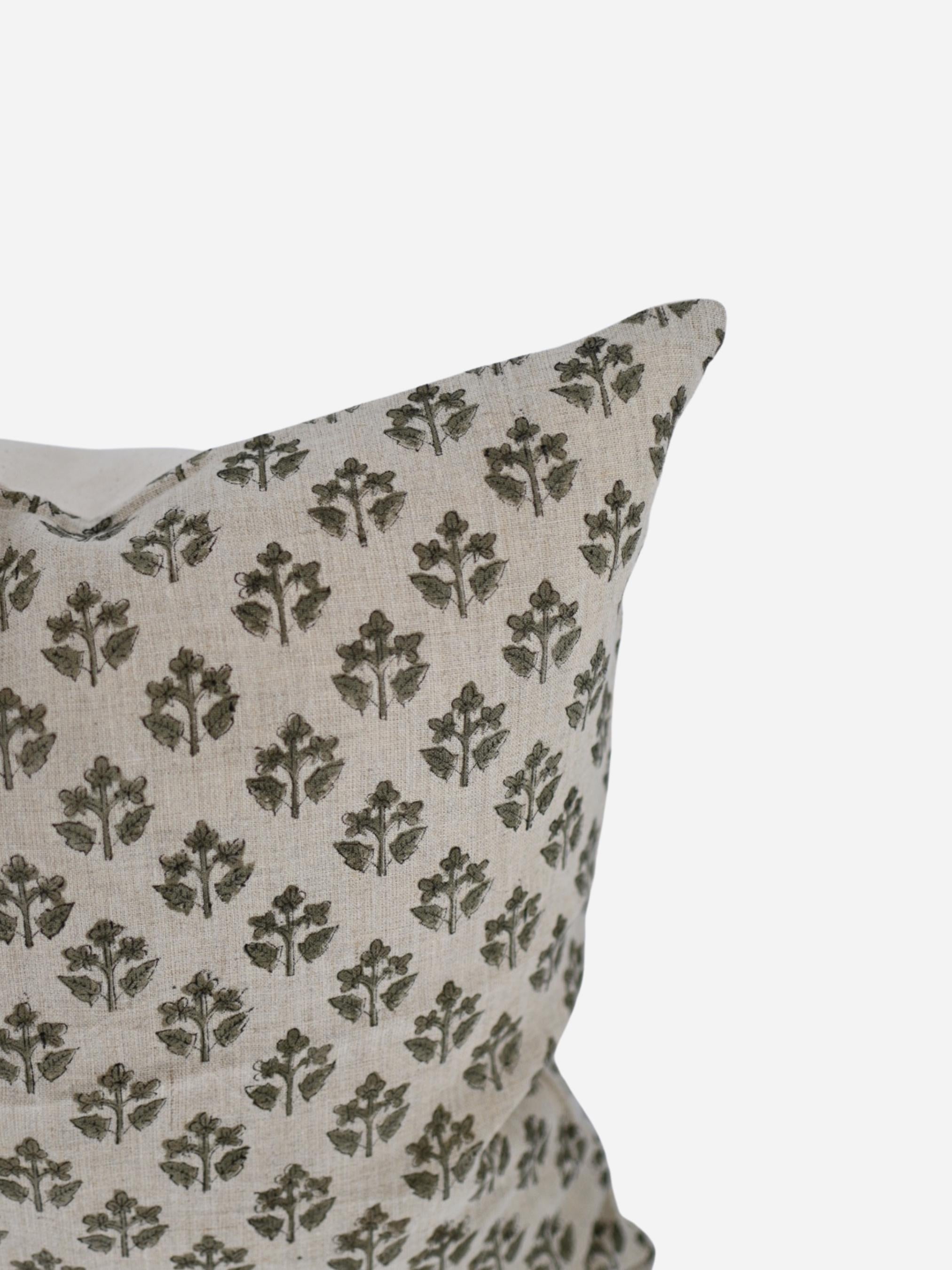 Close-up of the olive green sprig hand block print on natural linen