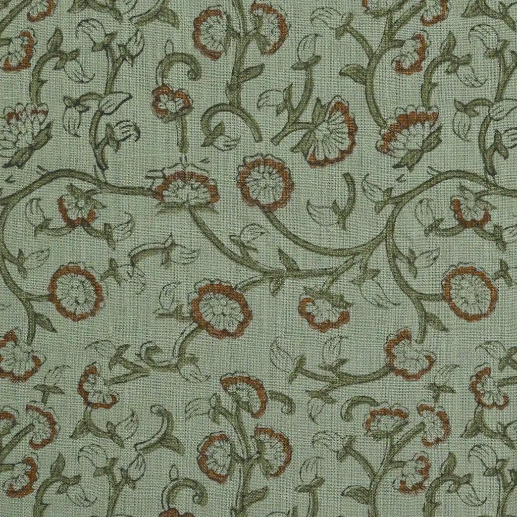 Sage green block print linen pillow cover styled on a sofa