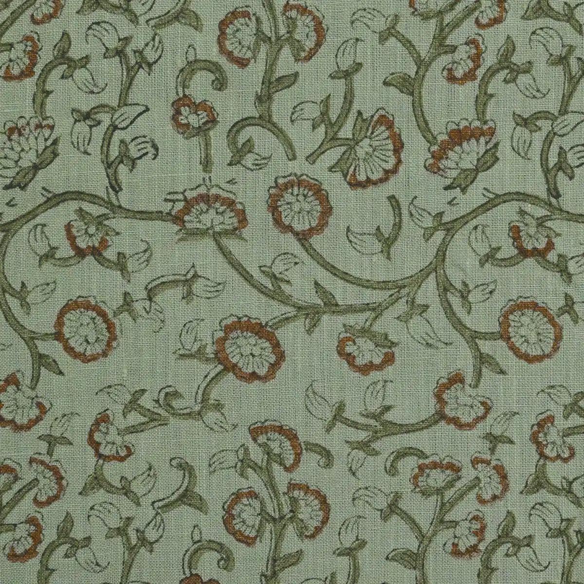 Sage green block print linen pillow cover styled on a sofa