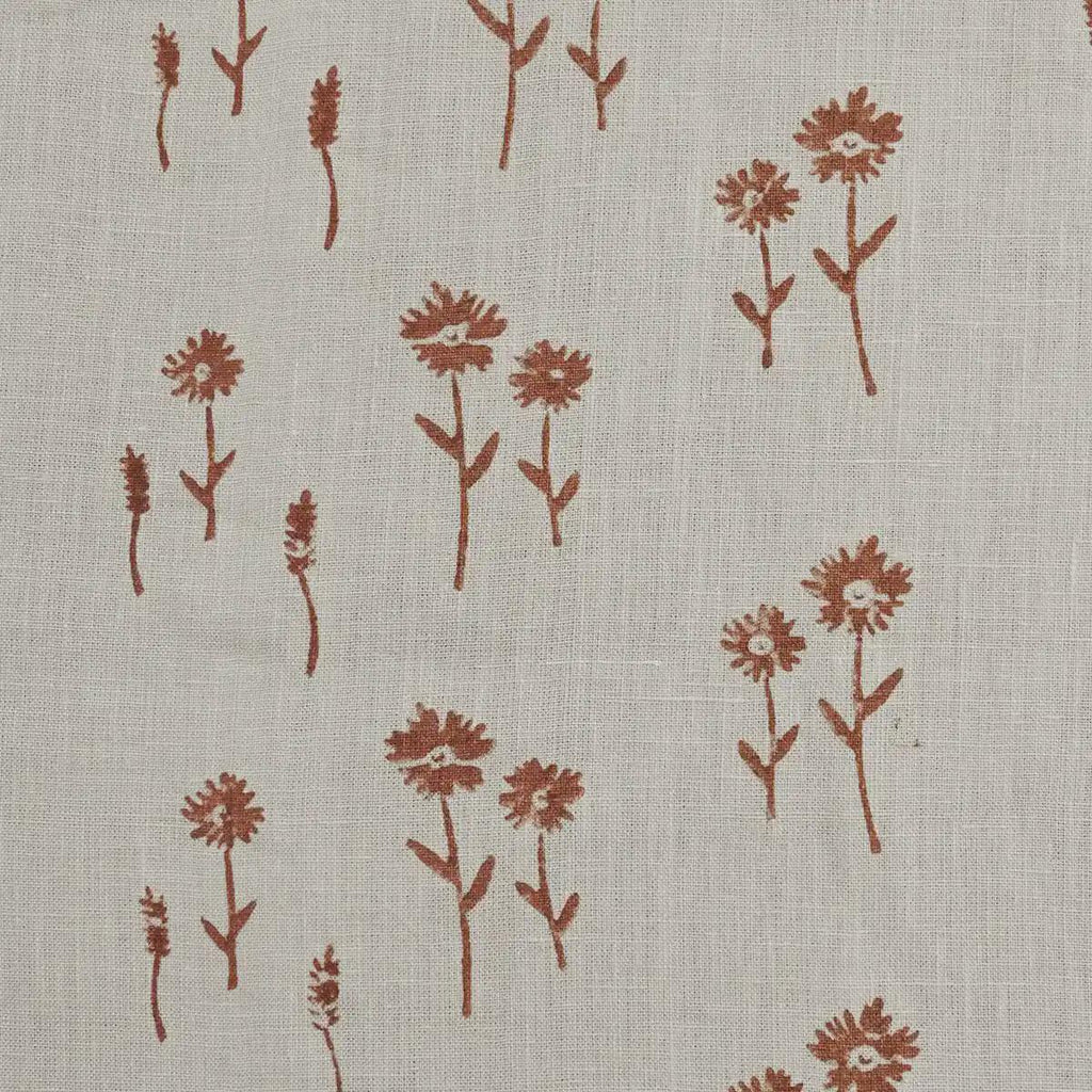 Rust floral block print linen pillow cover styled on a sofa