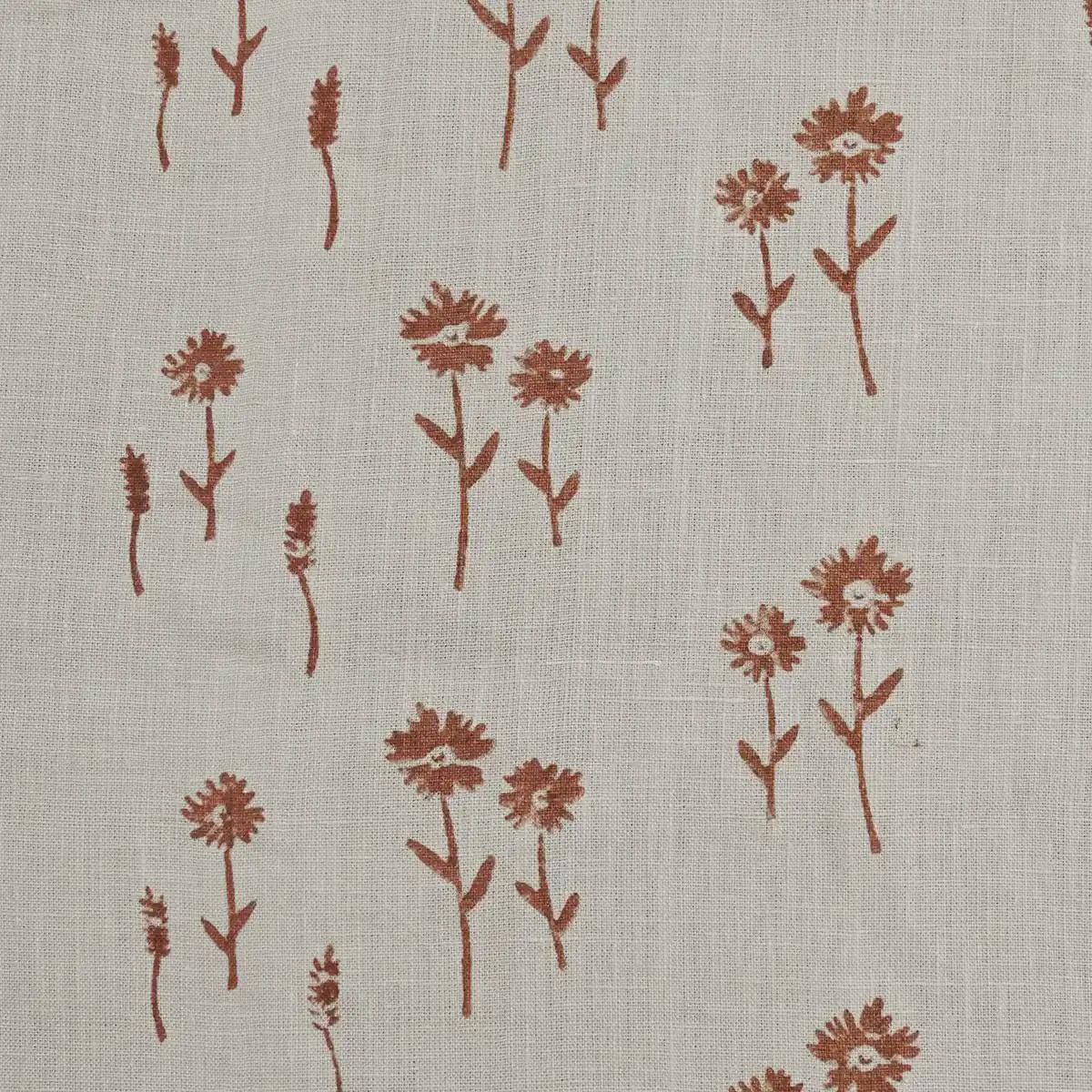 Rust floral block print linen pillow cover styled on a sofa
