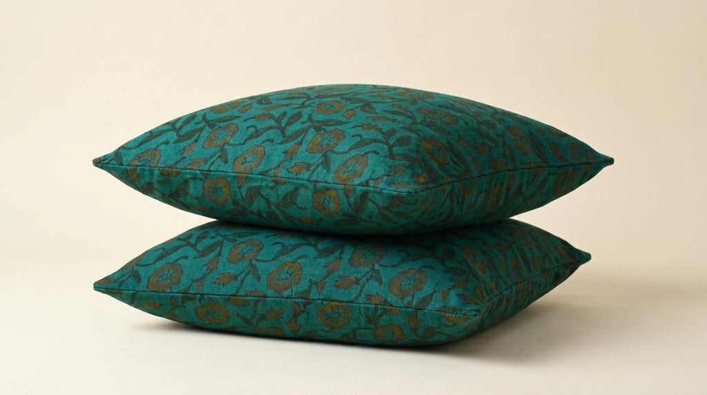 Teal wild rose pillow cover styled in a living room