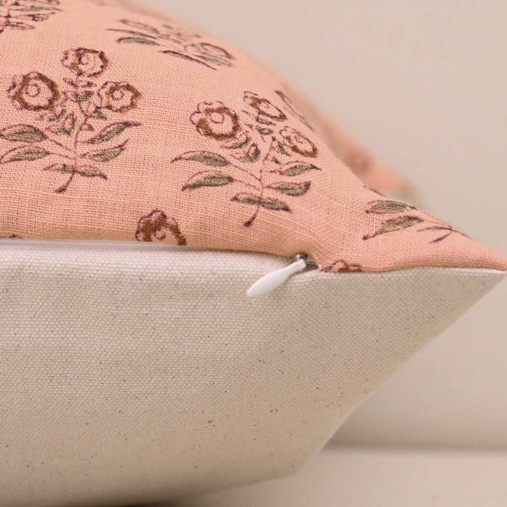Close-up of rust floral bouquet block print detail on peach linen pillow cover