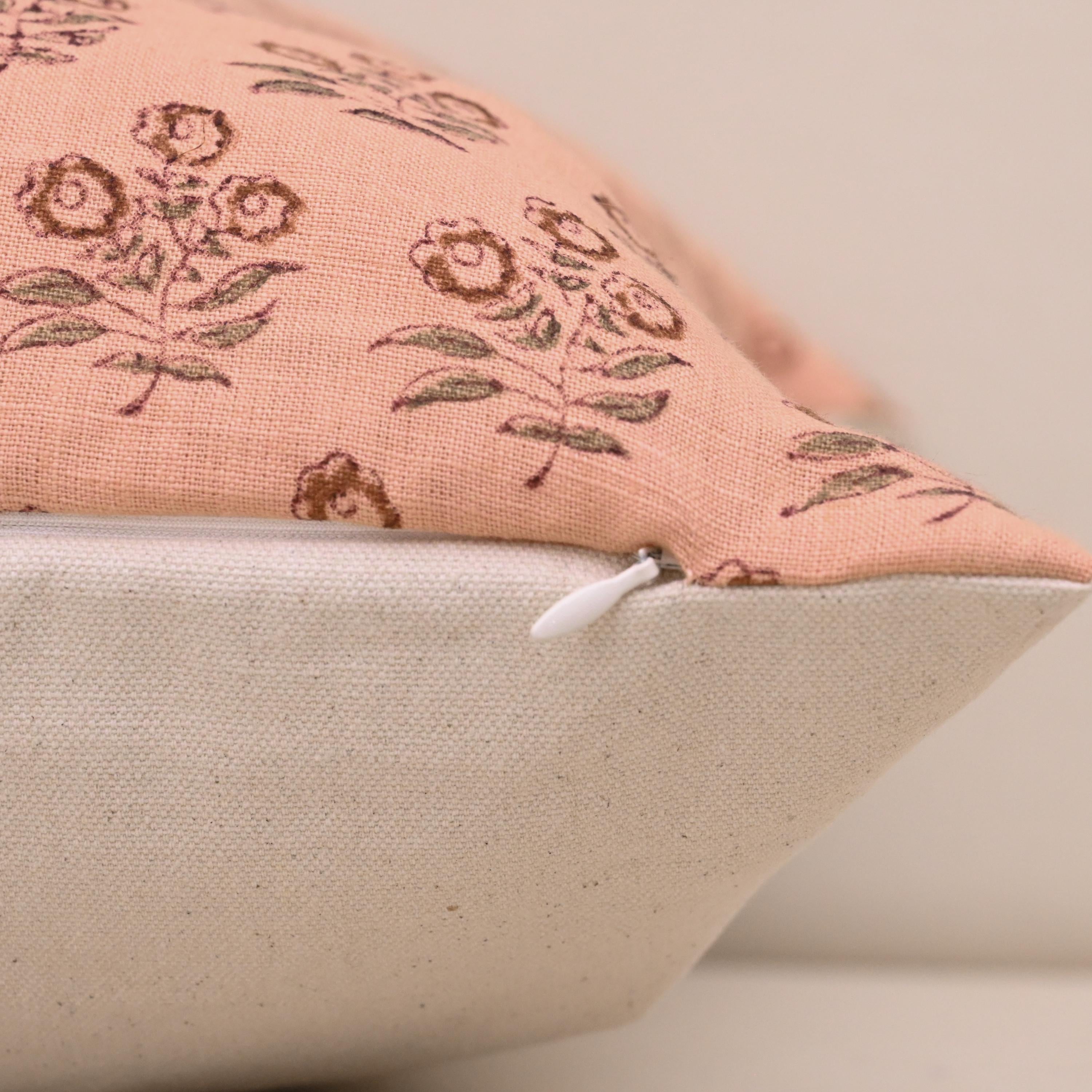 Close-up of rust floral bouquet block print detail on peach linen pillow cover