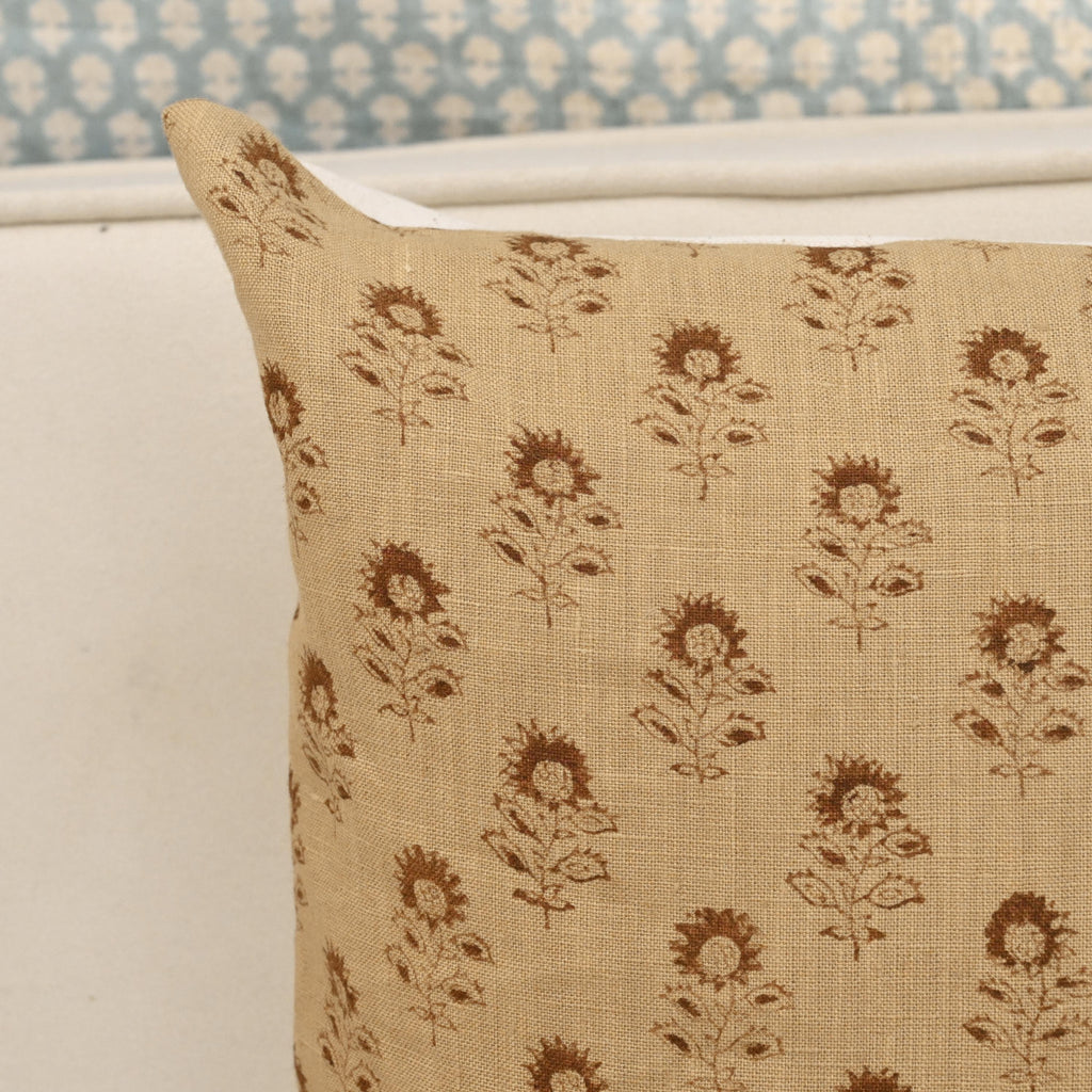 Close-up of the sunflower buti block print detail on camel linen