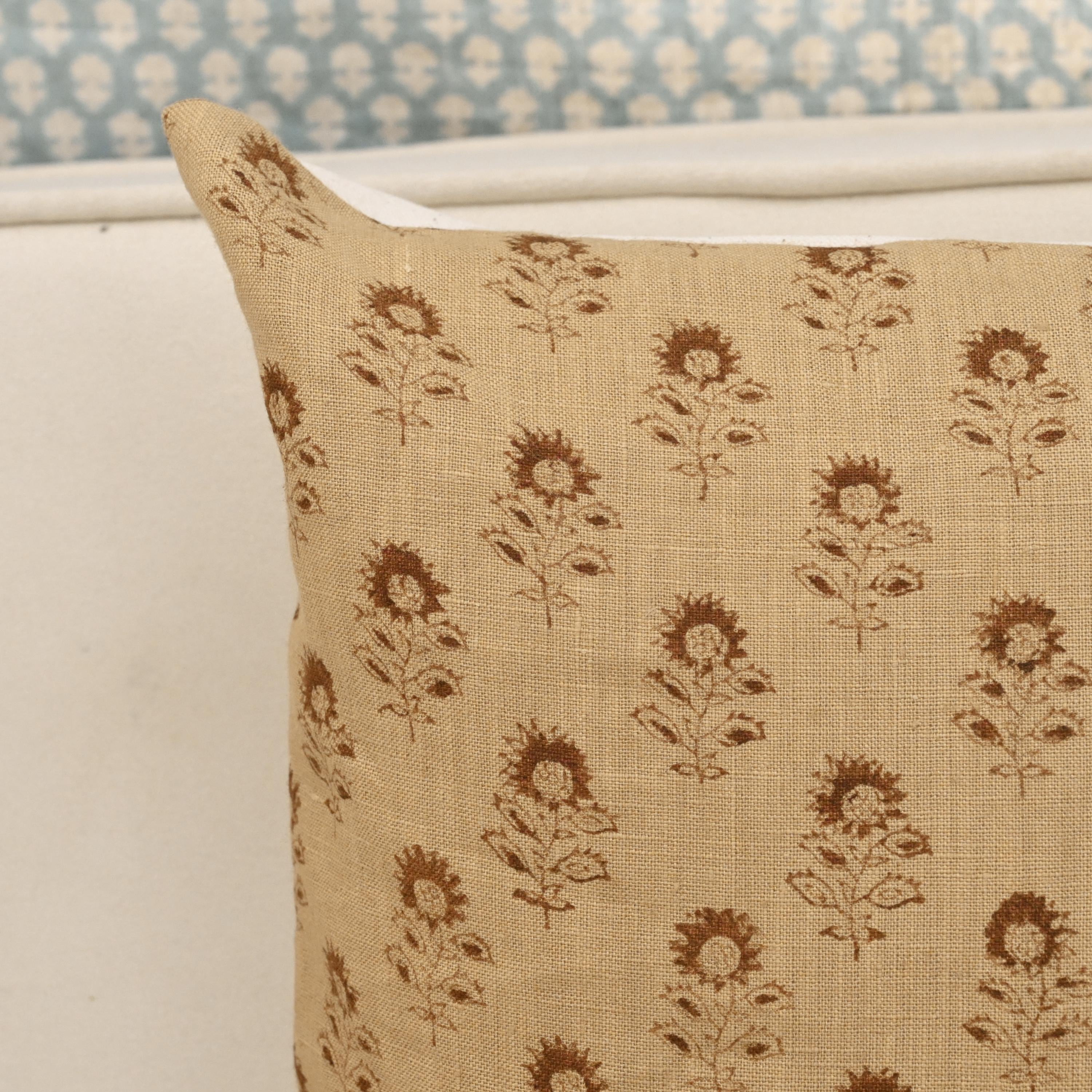 Close-up of the sunflower buti block print detail on camel linen