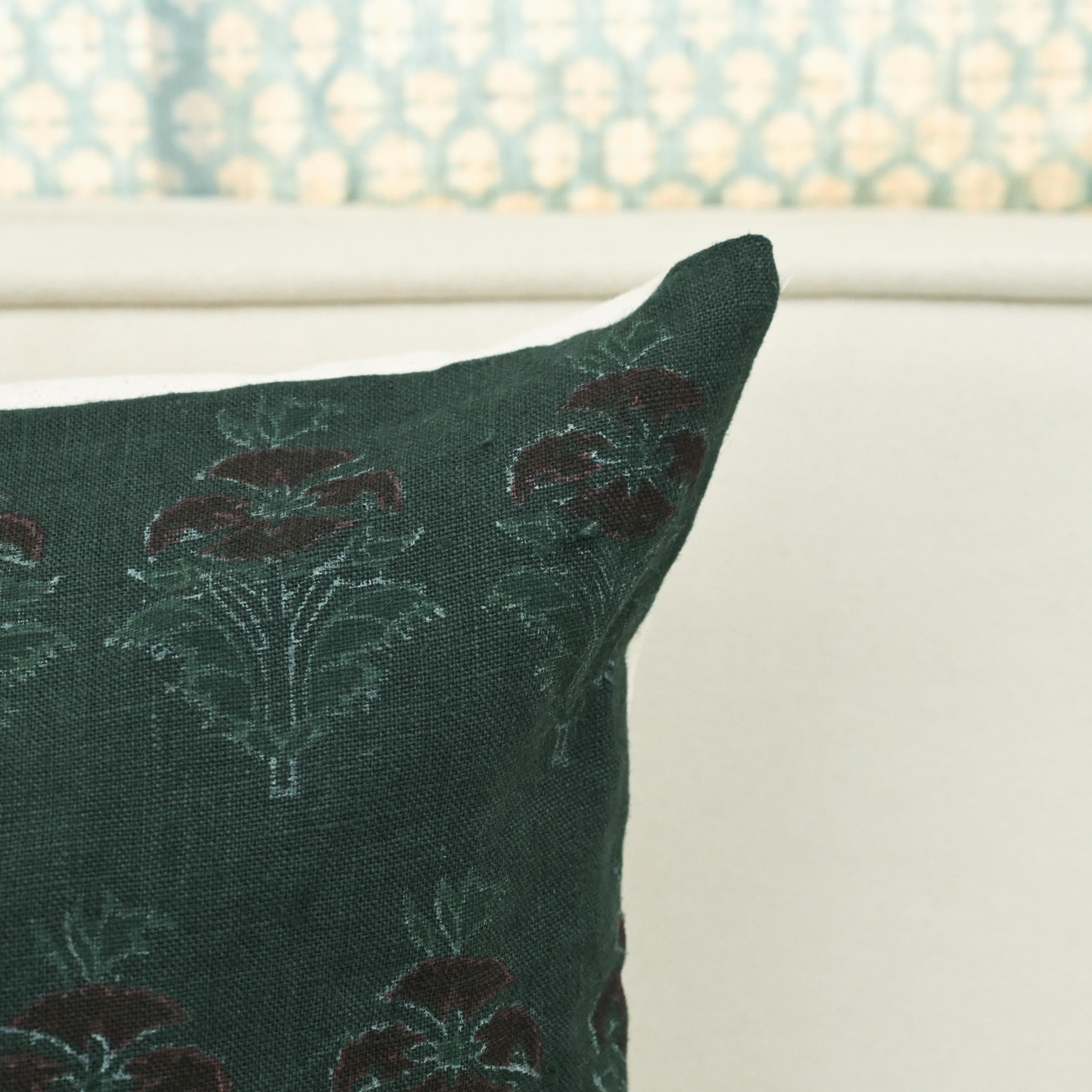 Close-up of hand block printed chintz bud pattern on forest green linen