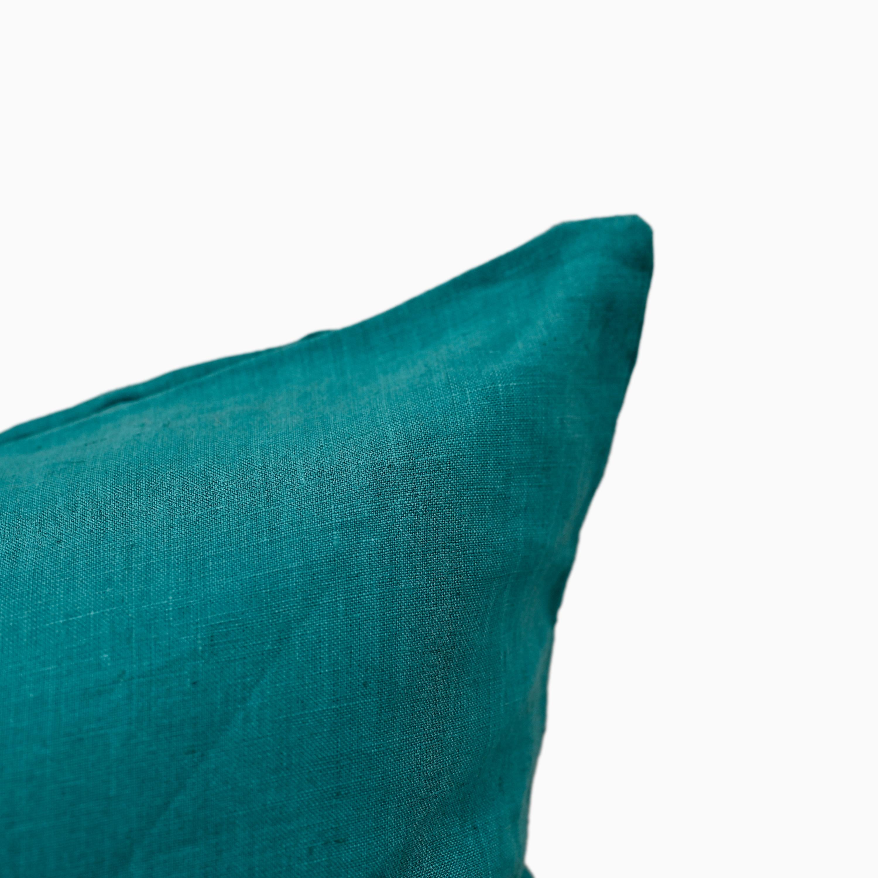 Close-up of deep teal linen pillow cover fabric texture and hidden zipper