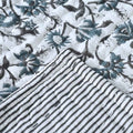Ice blue floral hand block print cotton quilt on twin size bed