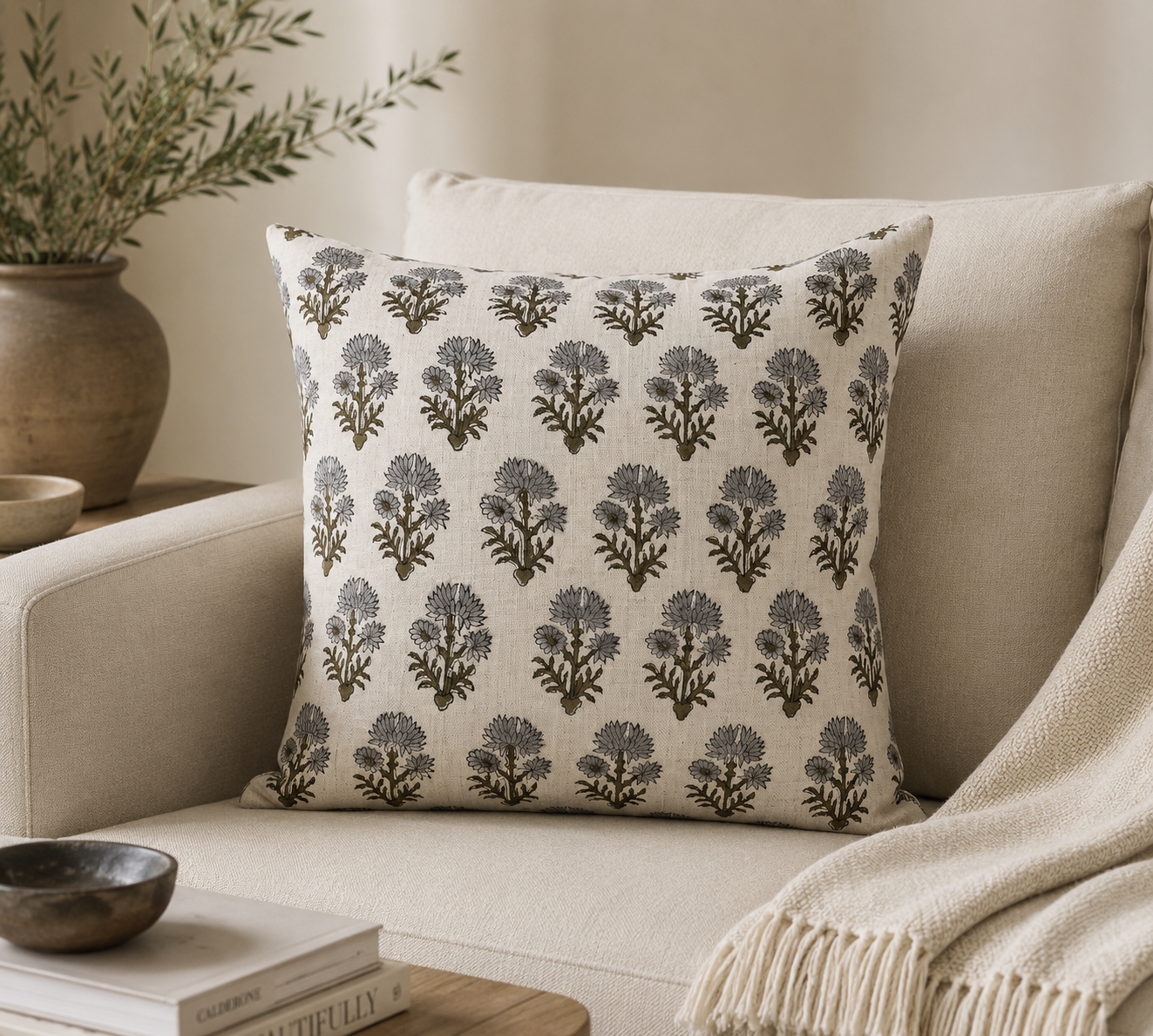 Floral hand block print linen pillow cover styled on a beige armchair in a boho living room