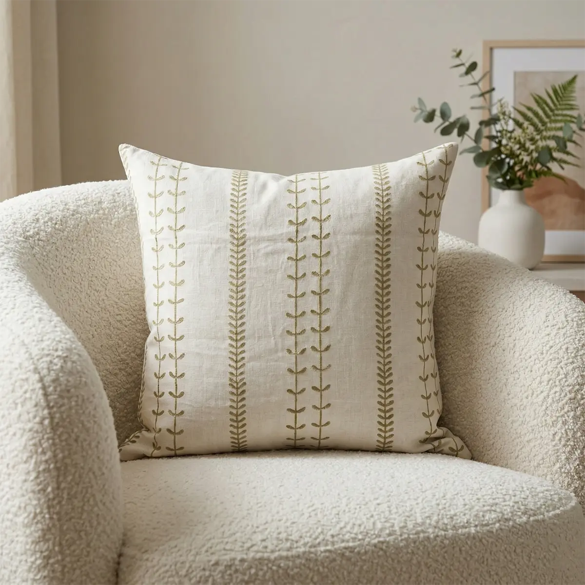 Block print linen cushion cover styled on a cream bouclé armchair