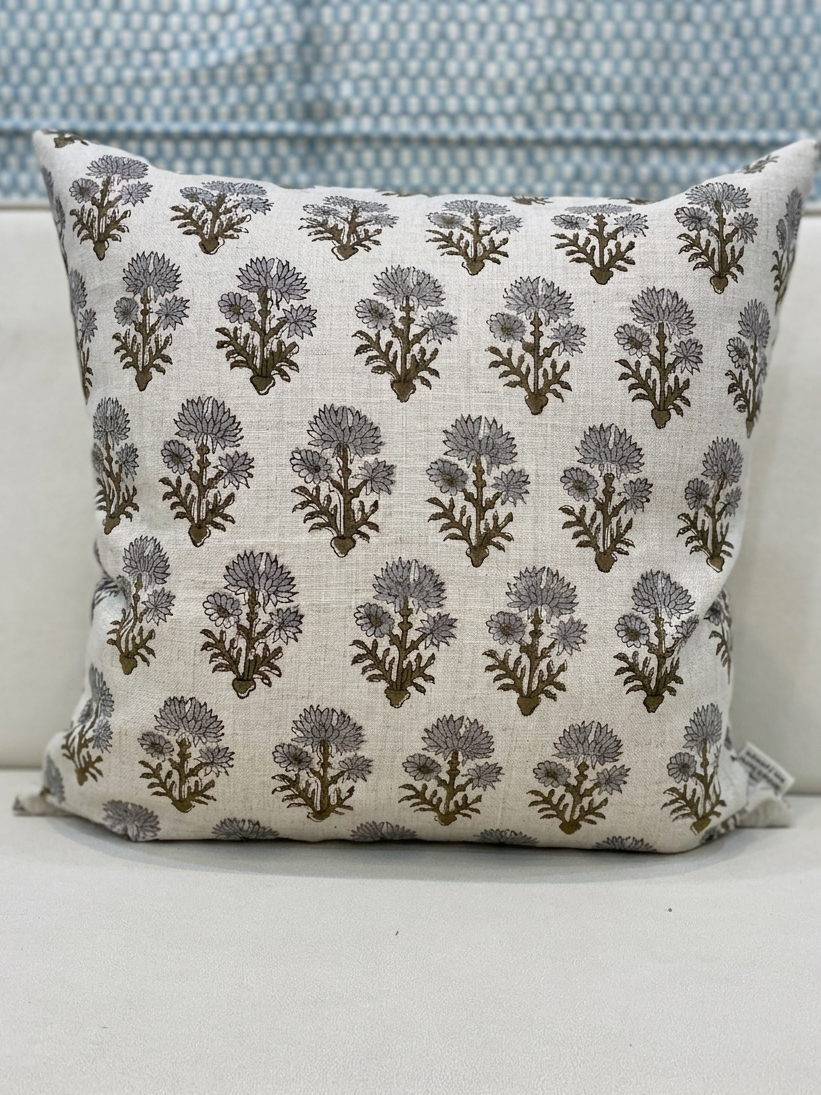 Handmade linen pillow cover with floral block print, shown with product tag on a sofa