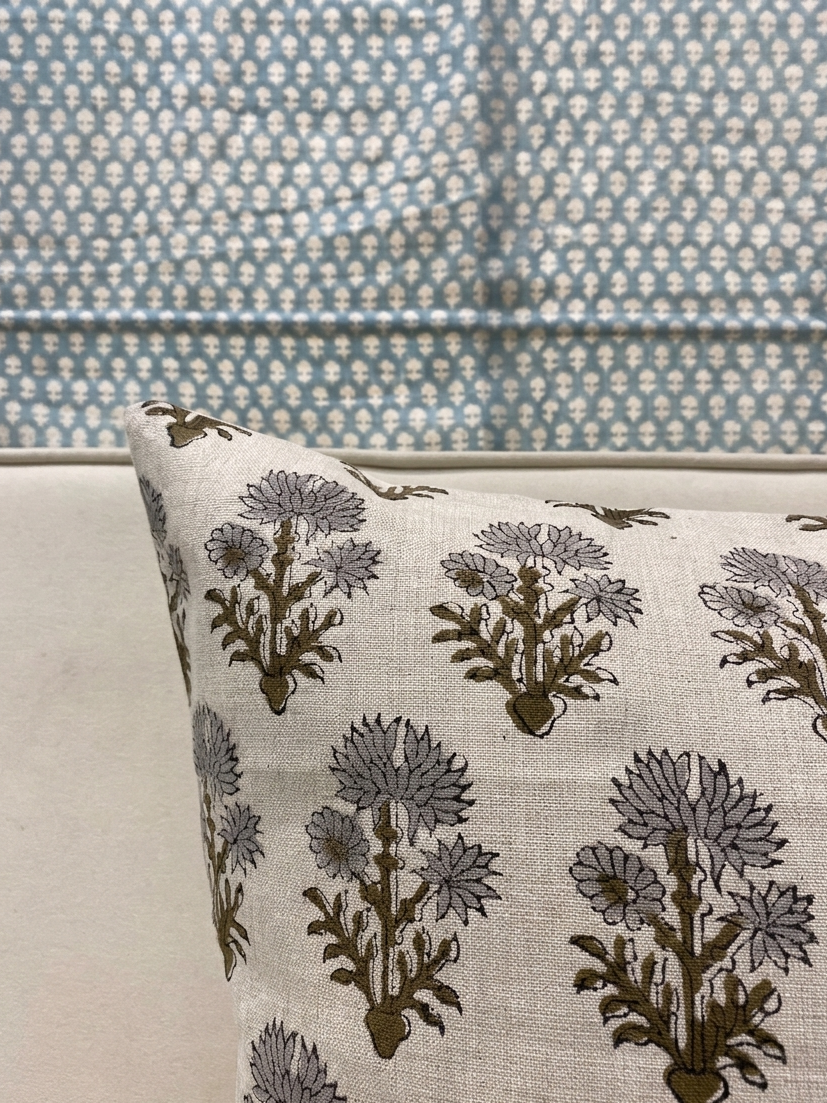 Corner detail of linen pillow cover showing block print floral pattern and stitching