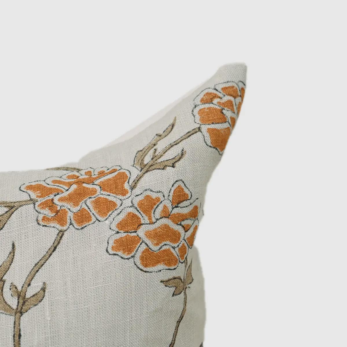 Marigold hand block print linen pillow cover styled on a sofa