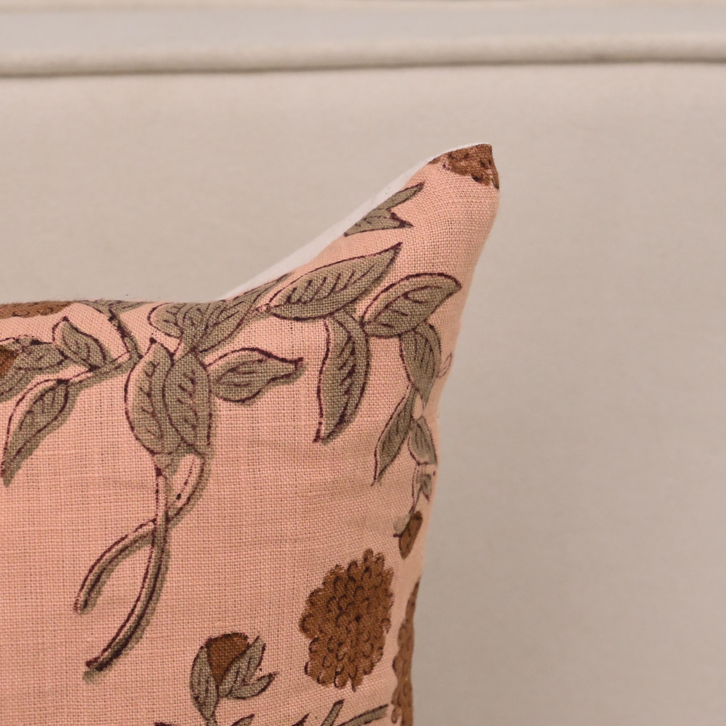 Peach floral linen cushion cover styled on a sofa