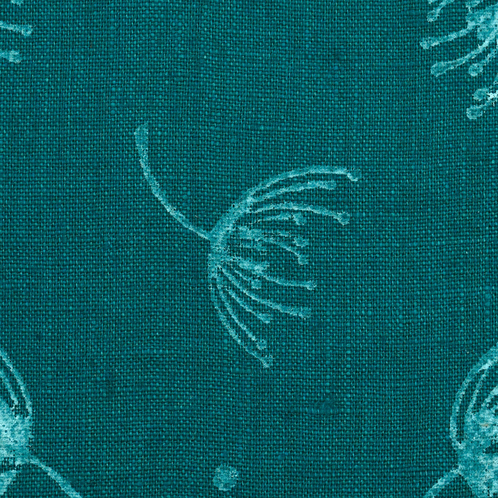 Close-up of hand block printed dandelion sprigs on teal linen