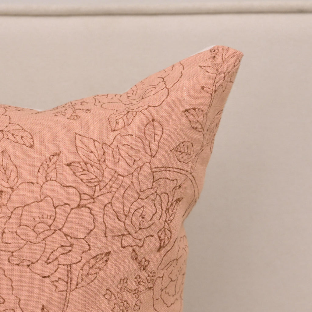 Close-up of brown rose floral block print detail on blush linen pillow cover