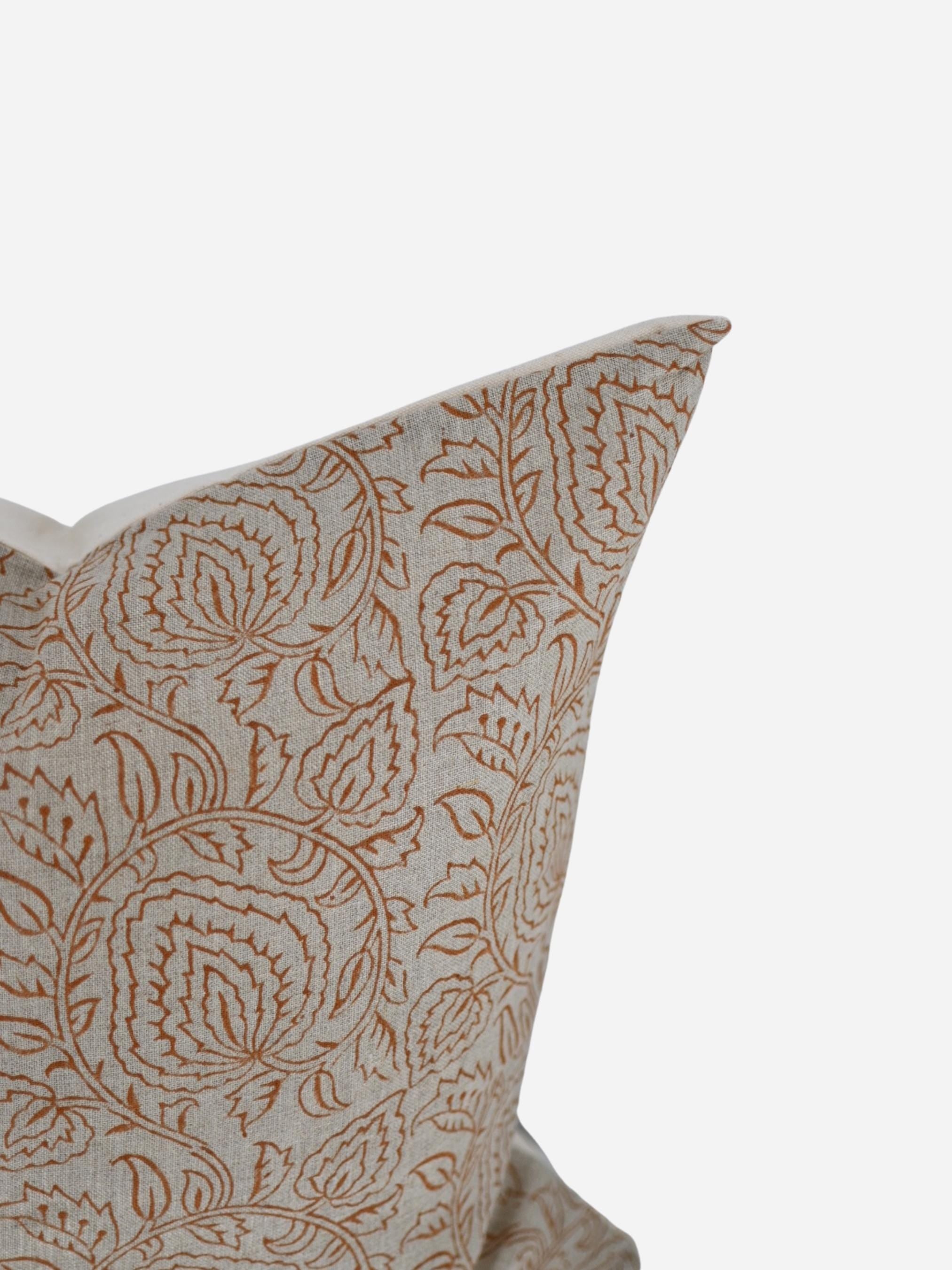 Close-up of the rust paisley vine hand block print on natural linen