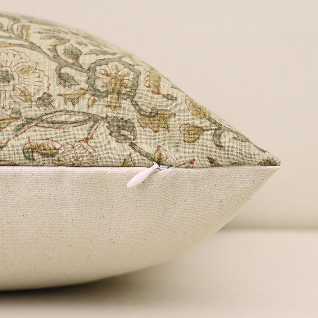 Close-up of sage rust floral vine block print detail on linen pillow cover