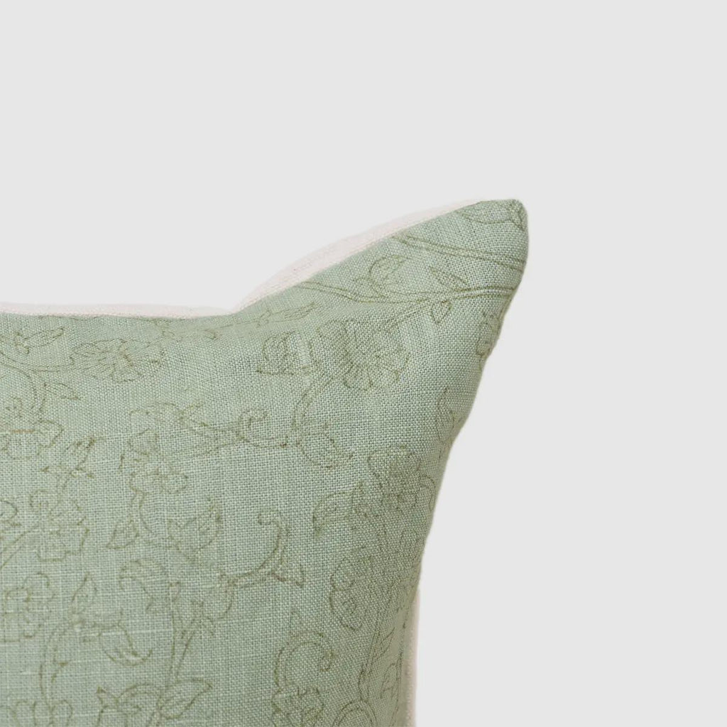Close-up of tonal botanical vine print on sage green linen