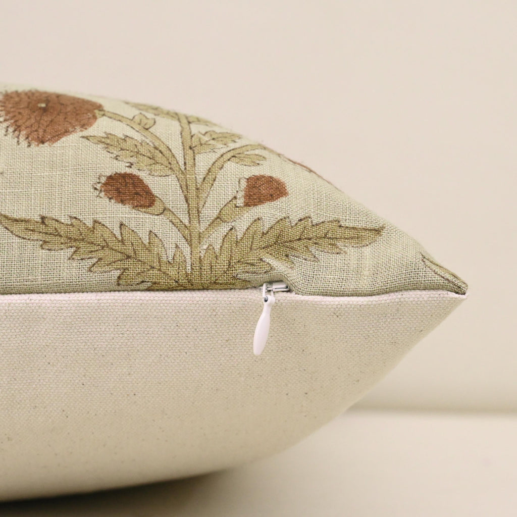 Close-up of rust dahlia floral block print detail on linen pillow cover