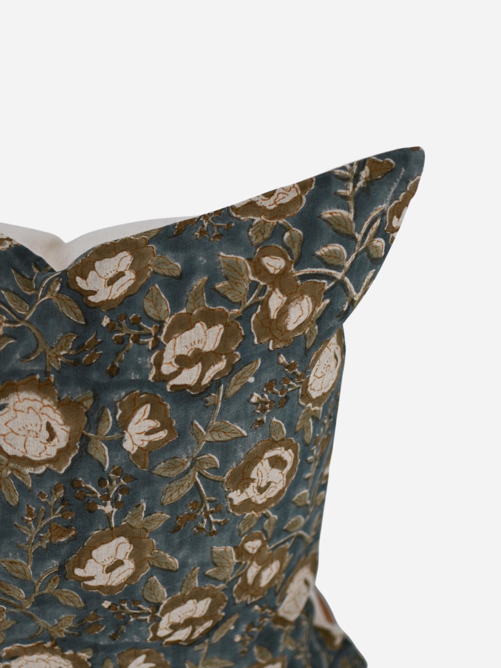 Close-up of the mustard rose floral hand block print on slate blue linen