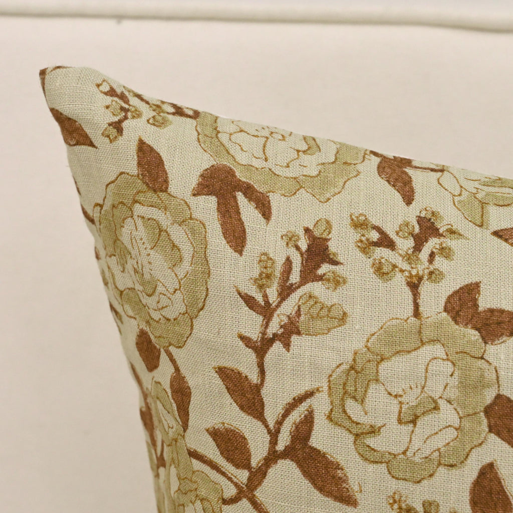 Sage rust floral linen pillow cover styled on a sofa