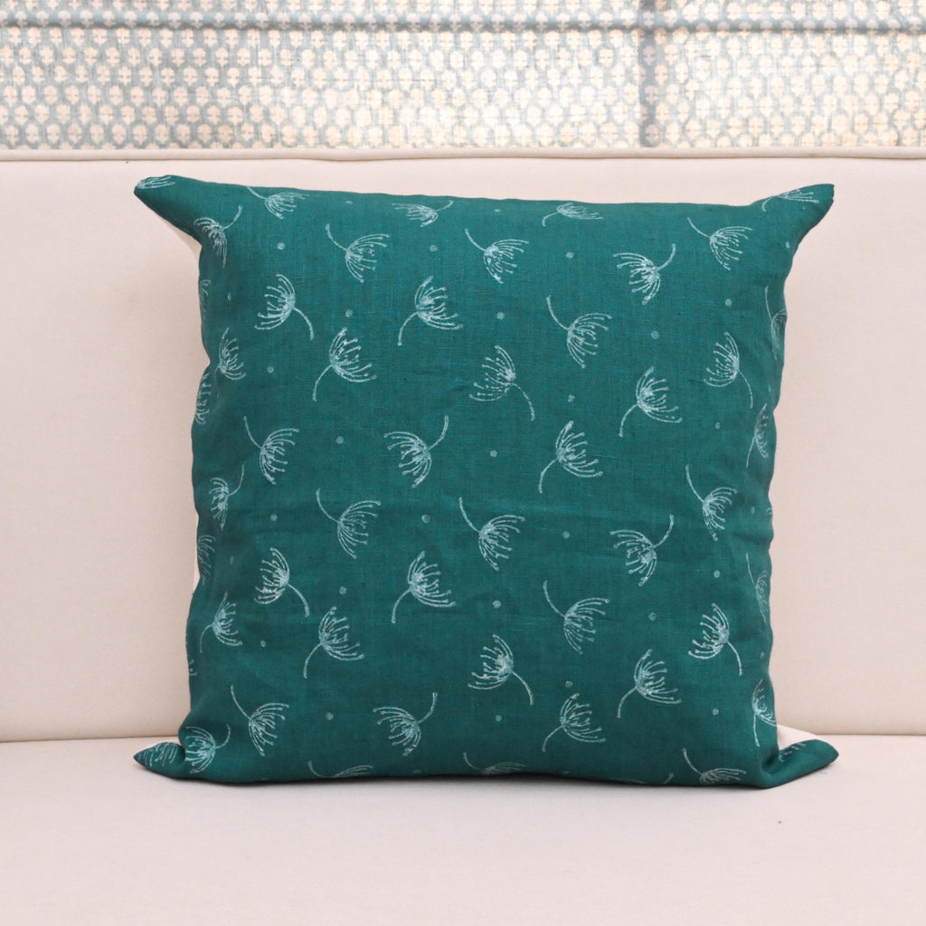 Teal wild meadow sprigs block print linen pillow cover styled on a sofa