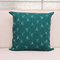 Teal wild meadow sprigs block print linen pillow cover styled on a sofa