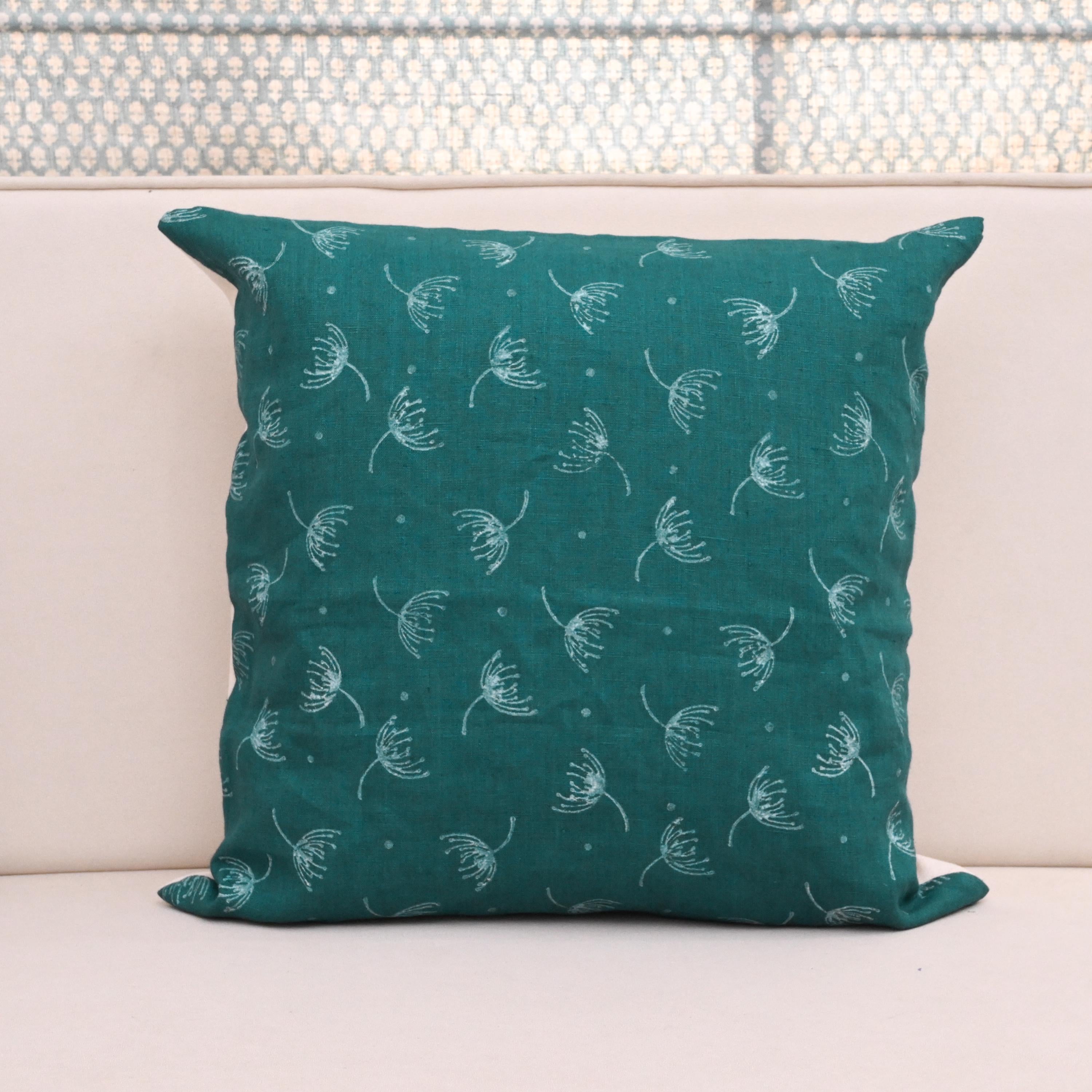 Teal wild meadow sprigs block print linen pillow cover styled on a sofa
