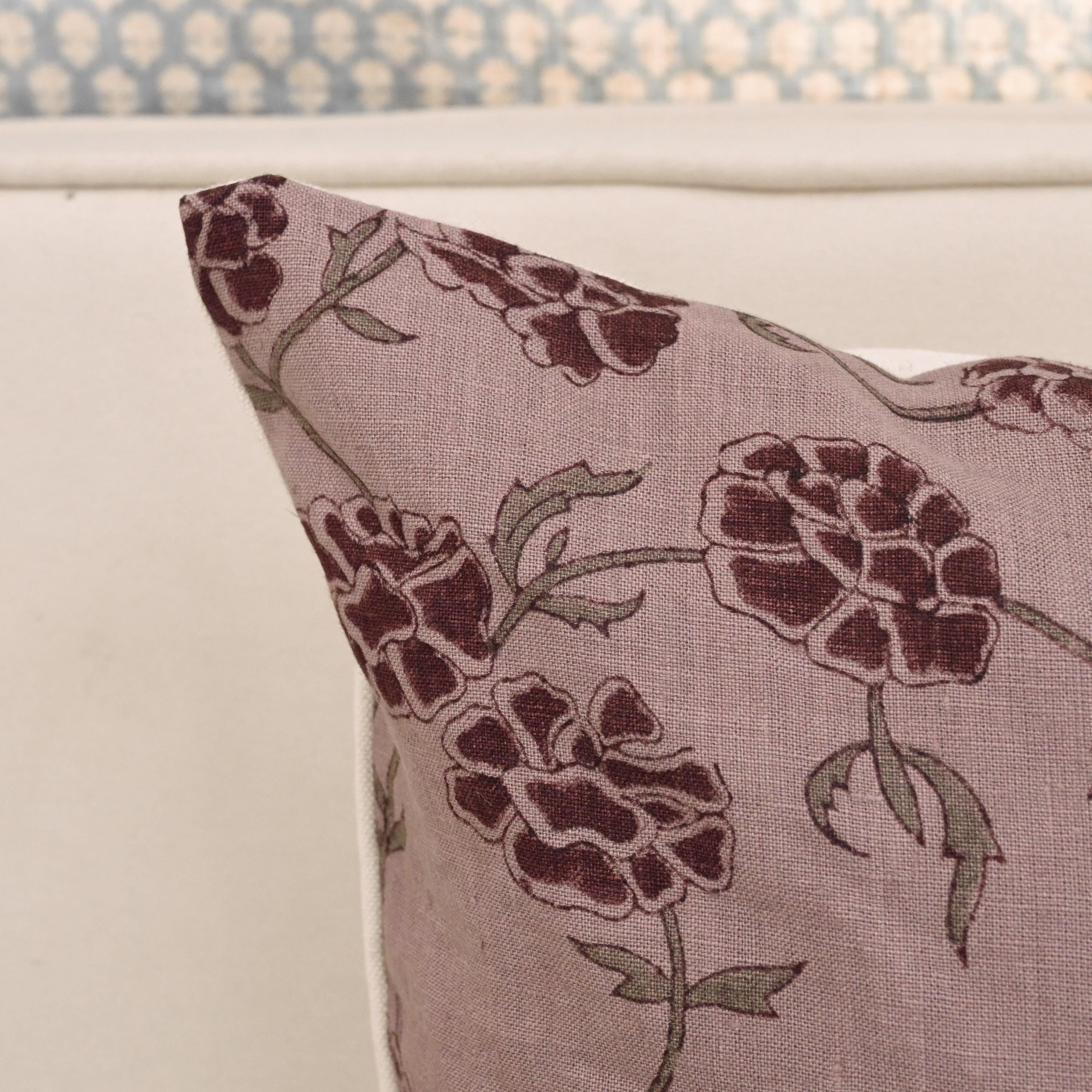 Mauve carnation block print linen pillow cover styled on a sofa