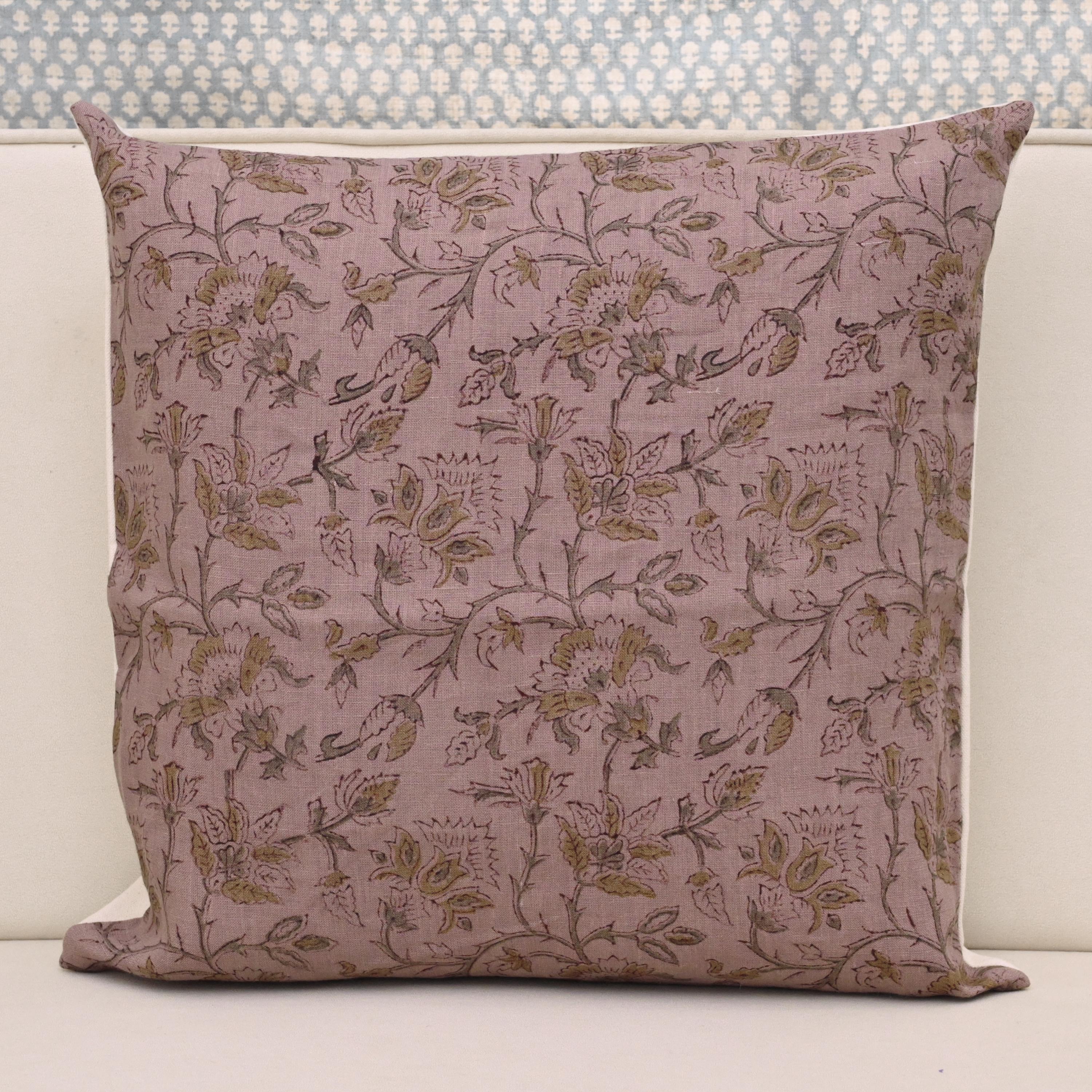 Muted gold floral hand block print linen pillow cover on dusty rose mauve background