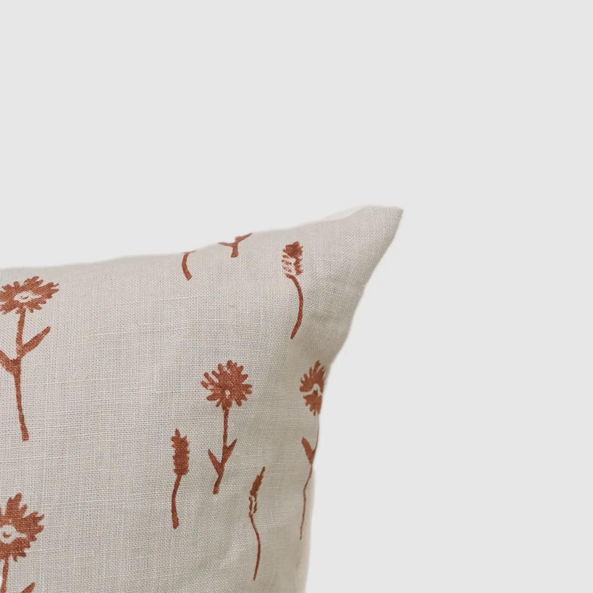Close-up of rust floral sprig print on ivory linen