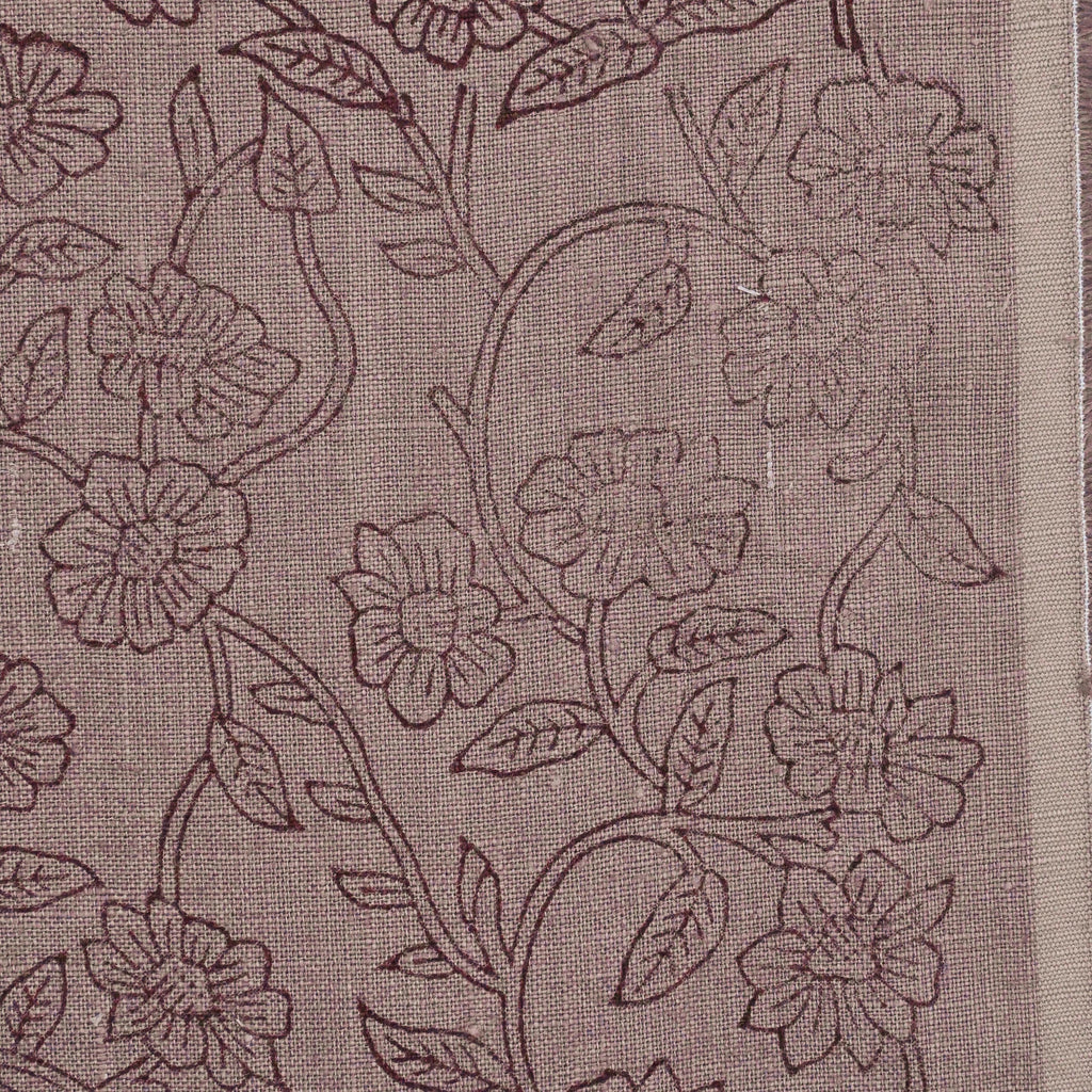 Close-up of the wine ditsy floral vine block print detail on mauve linen