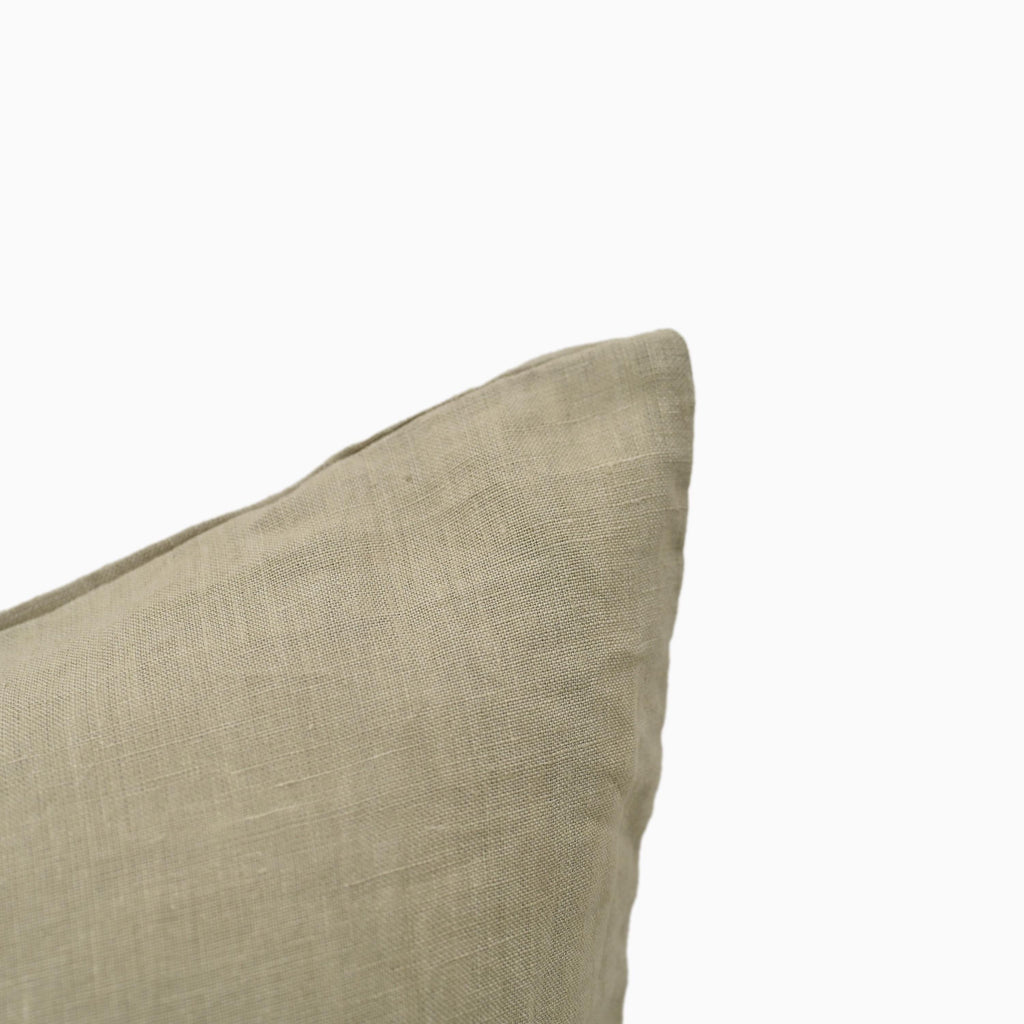 Close-up of grey linen pillow cover corner and stitching detail