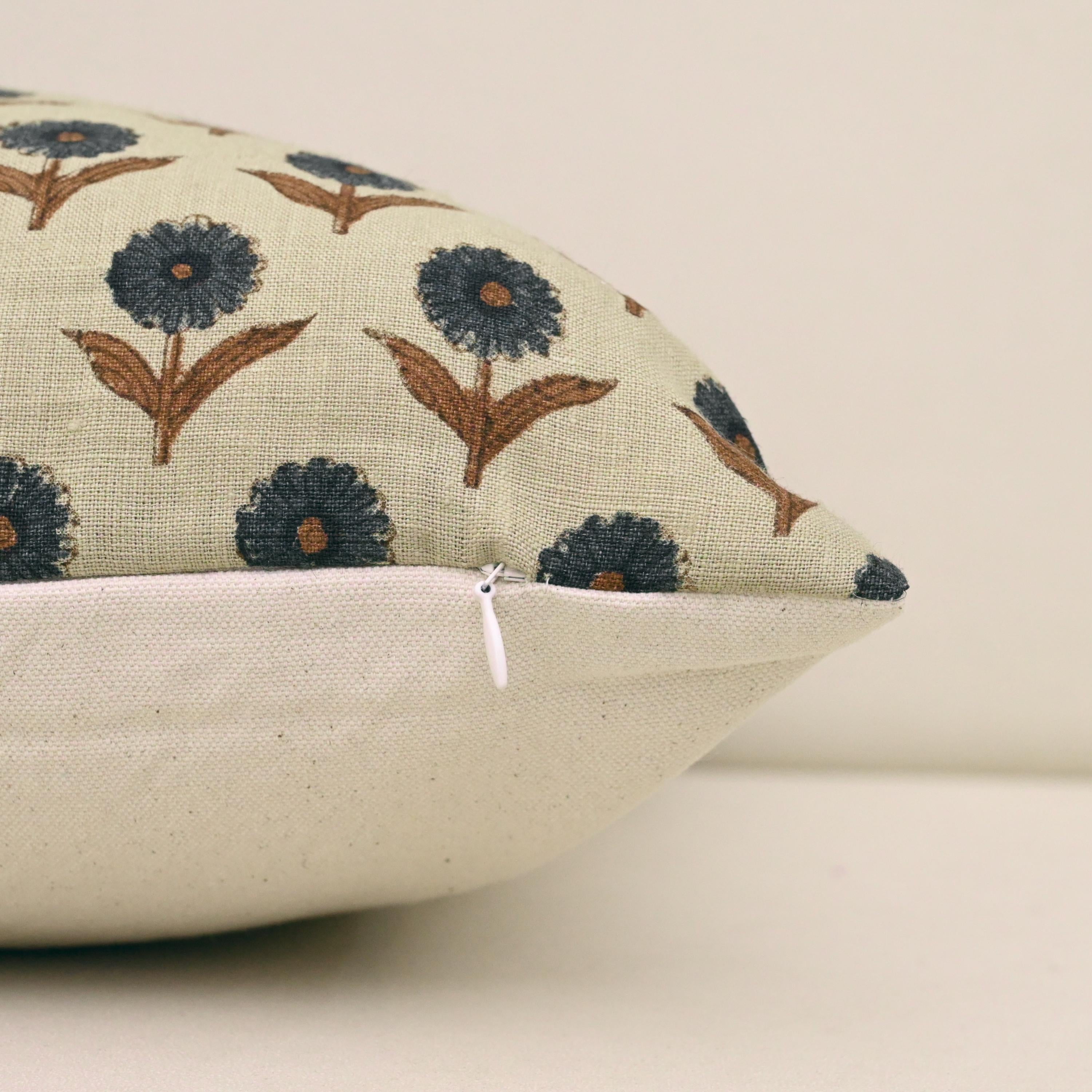 Close-up of navy floral block print with rust brown accents on linen pillow cover