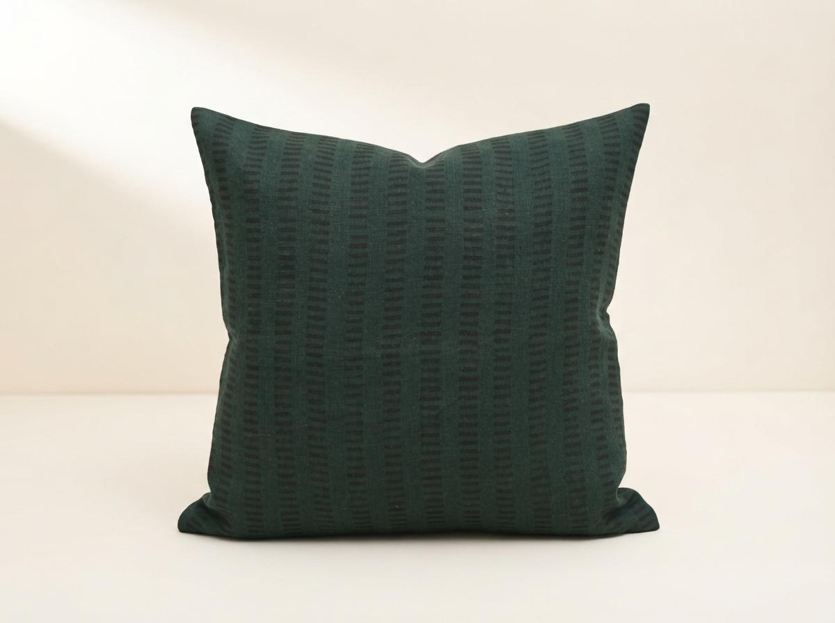 Forest green geometric stripe block print linen pillow cover on a sofa