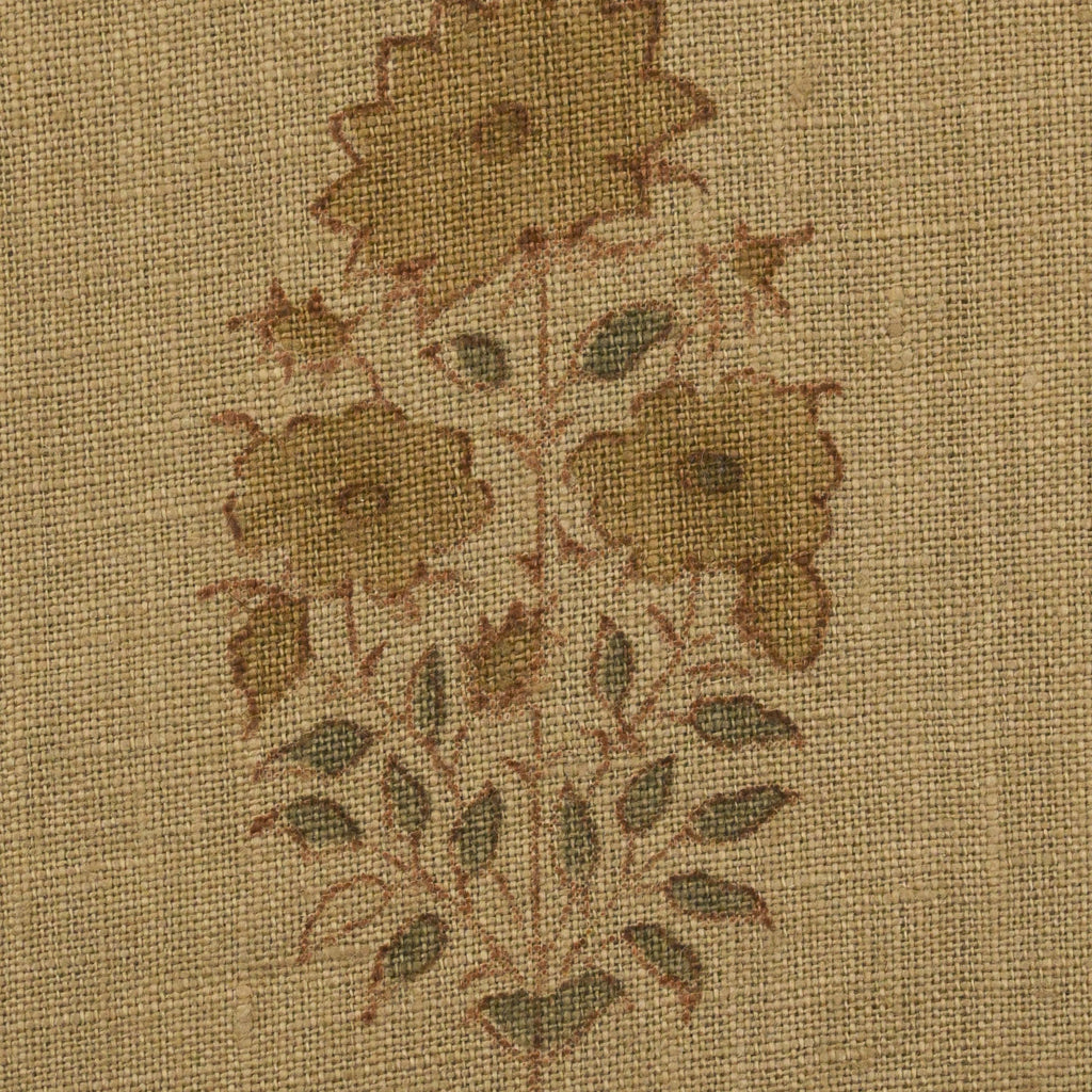 Close-up of the tawny brown floral buti block print detail on camel linen