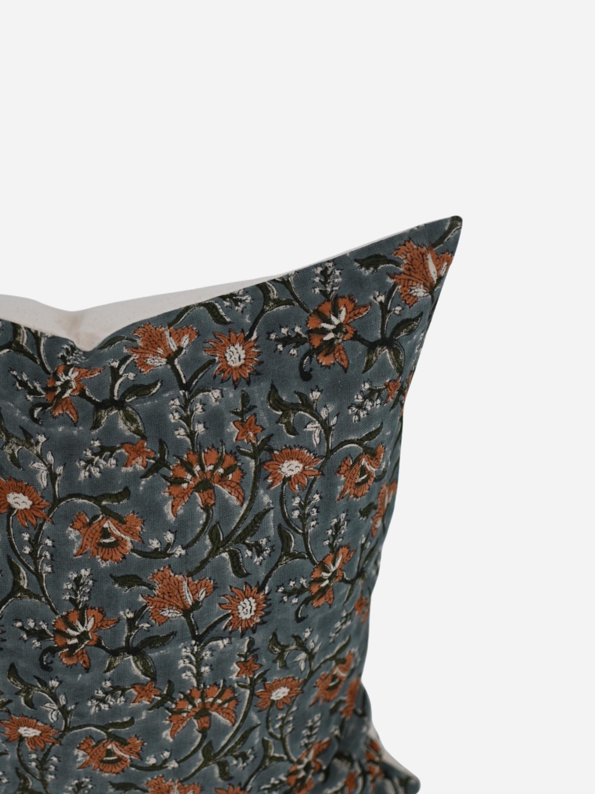 Close-up of the rust floral hand block print on slate blue linen